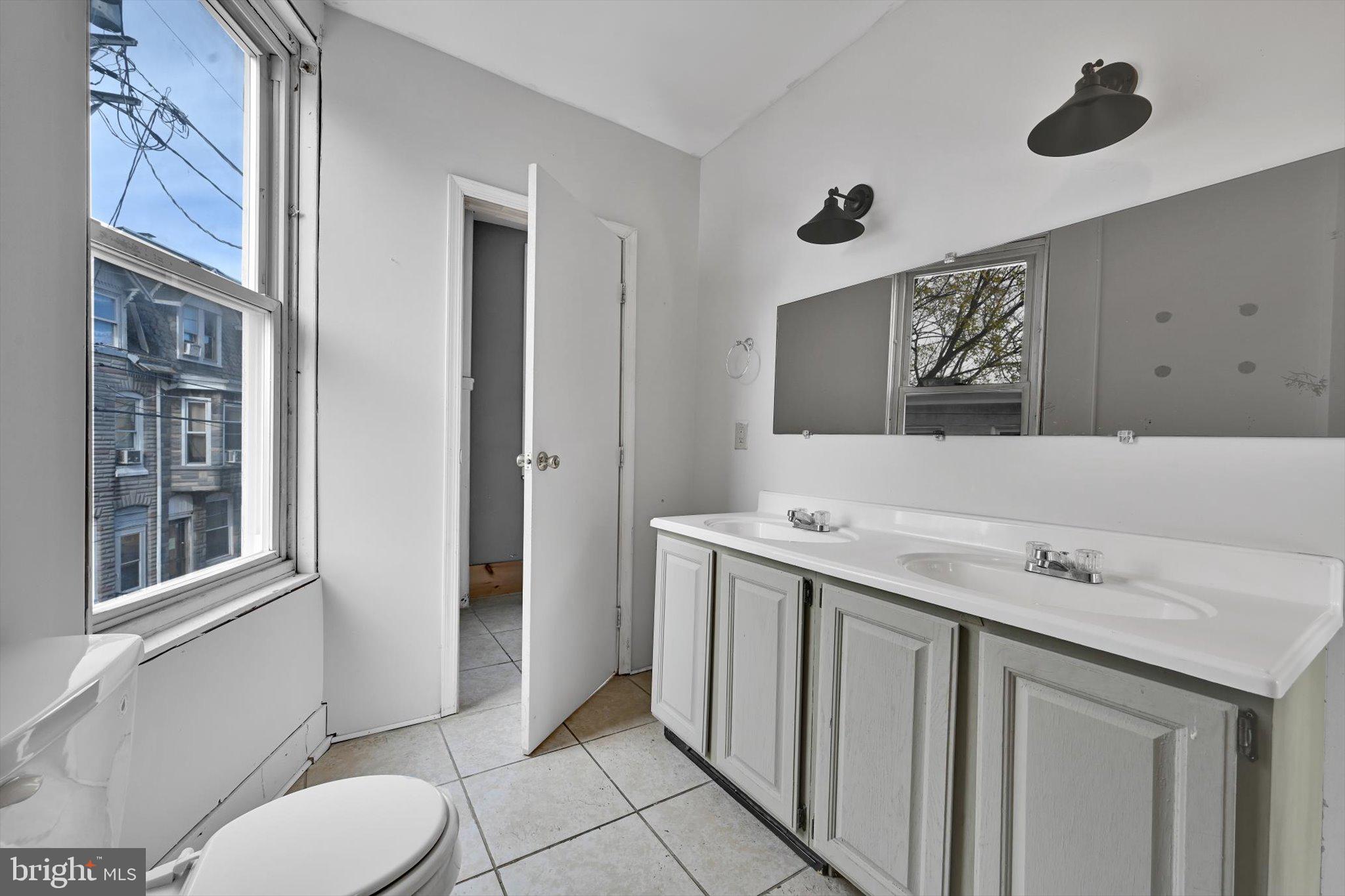 525 Bingaman Street Reading, PA 19602 - Photo 17 of 27 a bathroom with a sink and mirror