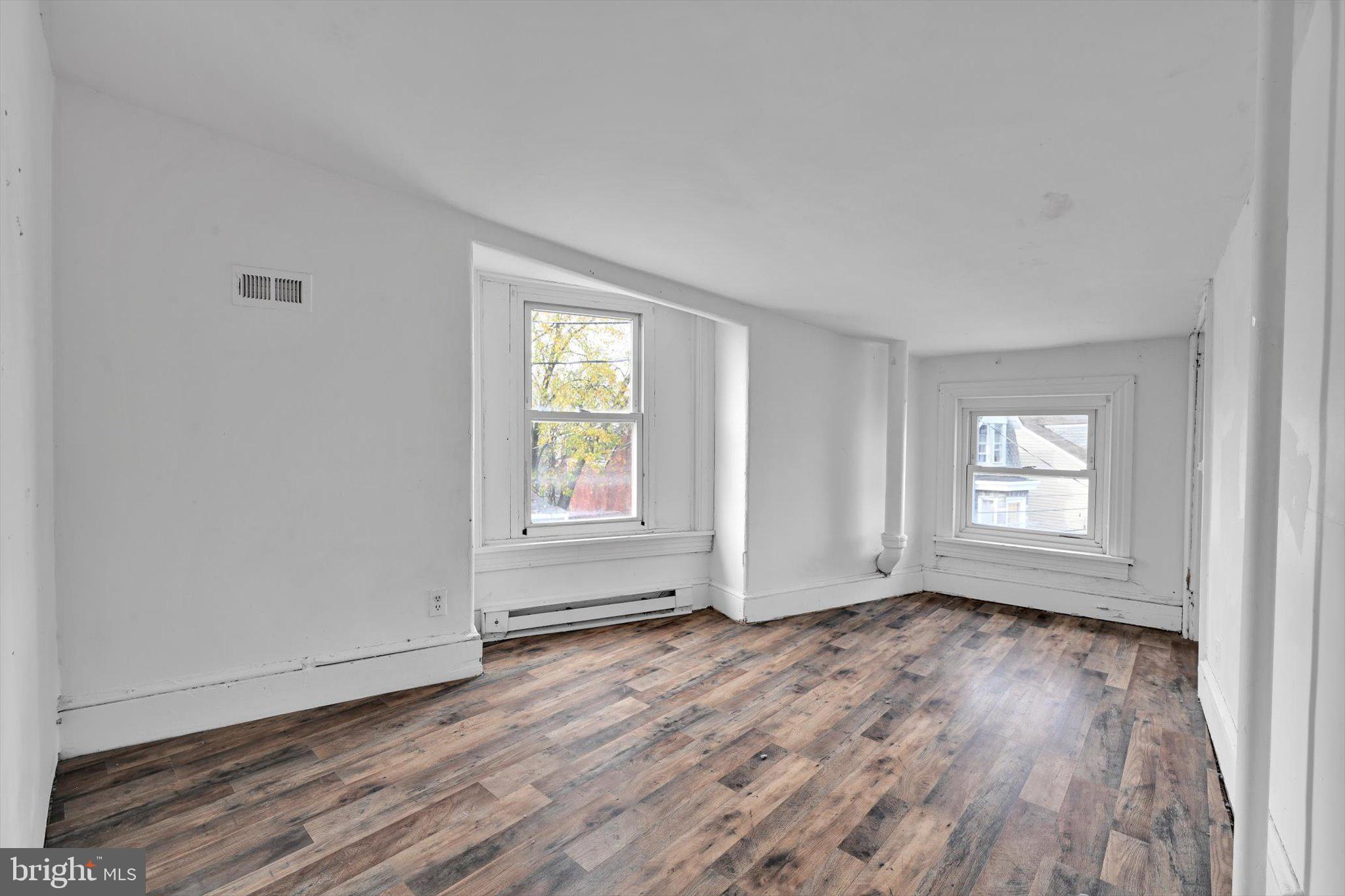 525 Bingaman Street Reading, PA 19602 - Photo 21 of 27 an empty room with wooden floor and windows
