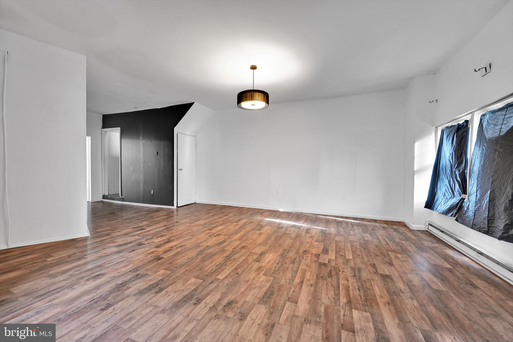 525 Bingaman Street Reading, PA 19602 - Photo 5 of 27 a view of an empty room with wooden floor and a window