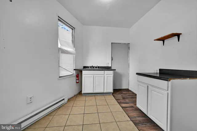 a kitchen with a cabinets and white appliances