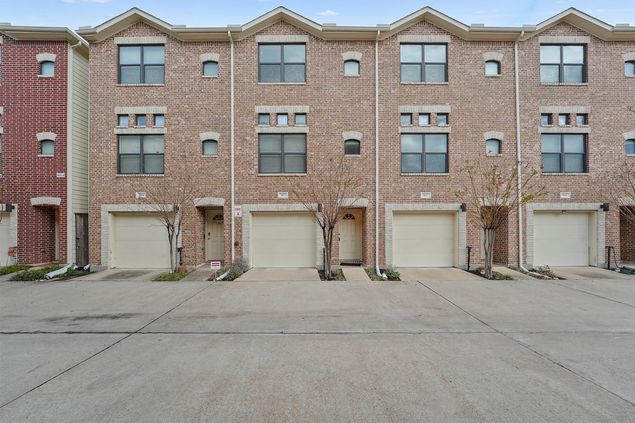 2710 Hullsmith Drive, Unit 903 Houston, TX 77063 - Photo 1 of 26 a view of a brick house with many windows