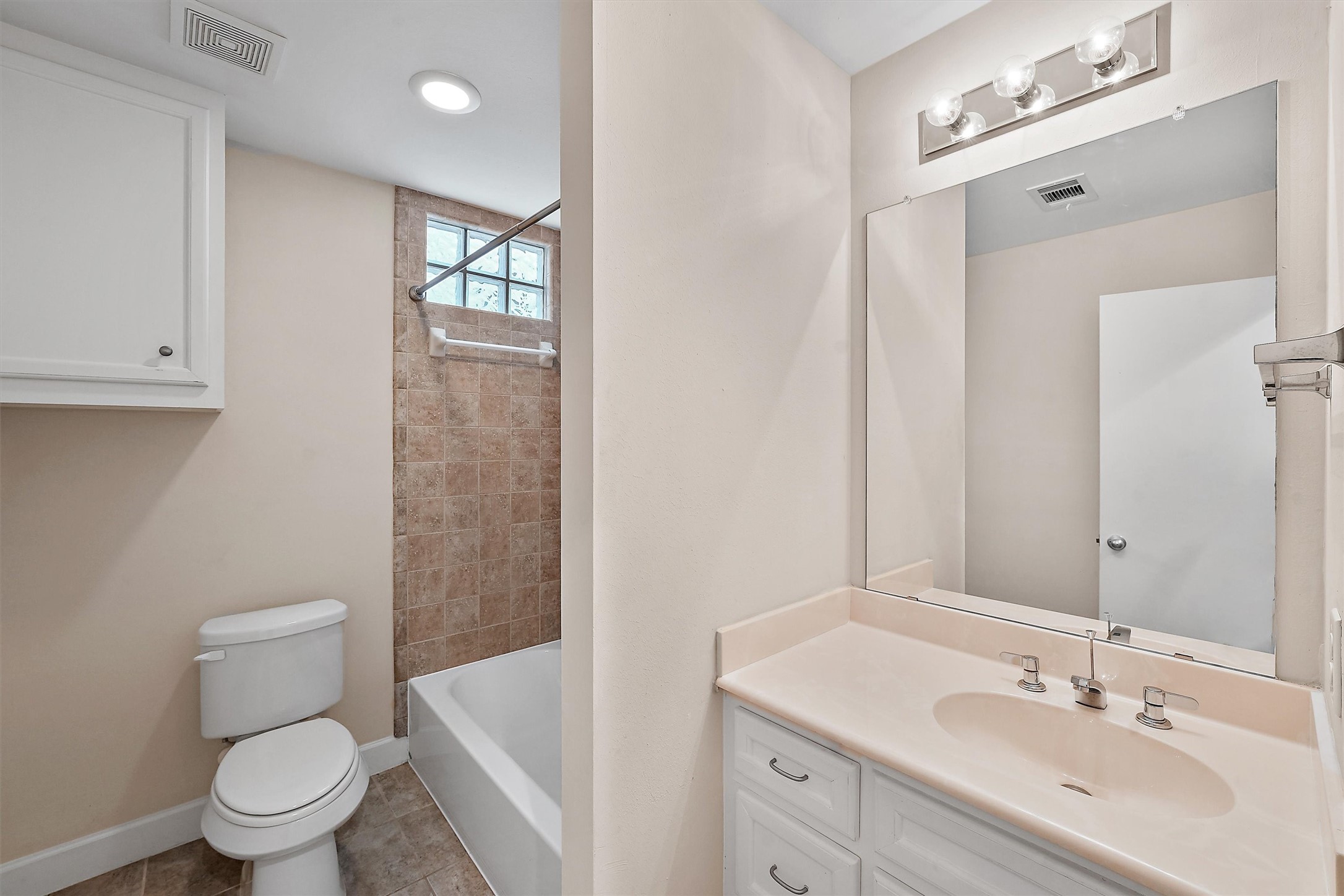 2710 Hullsmith Drive, Unit 903 Houston, TX 77063 - Photo 15 of 26 a bathroom with a toilet a sink a mirror and vanity