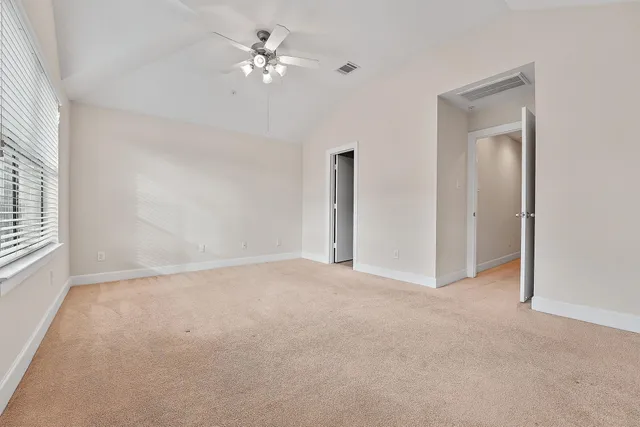 an empty room with fan and entrance