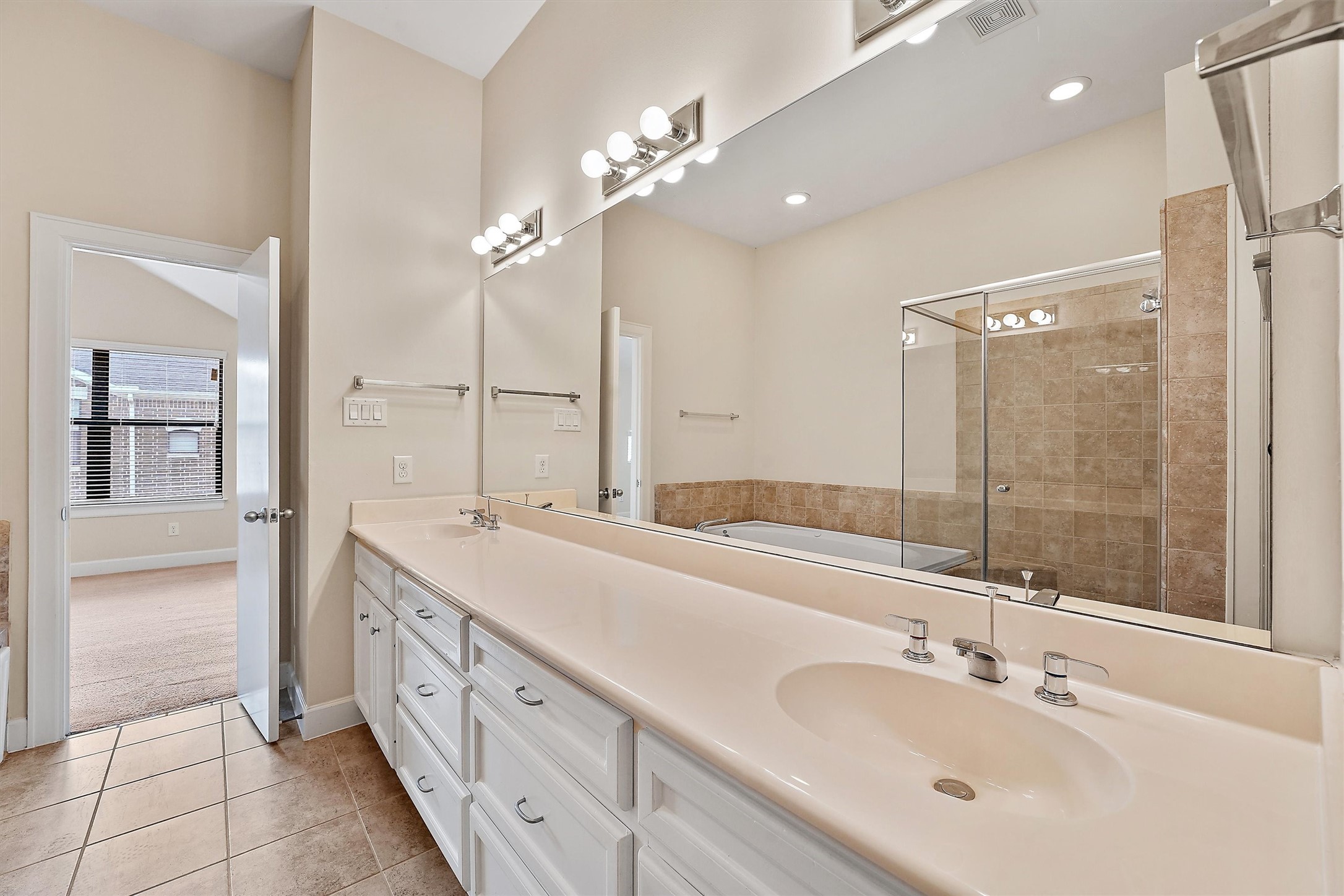 2710 Hullsmith Drive, Unit 903 Houston, TX 77063 - Photo 24 of 26 a spacious bathroom with a double vanity sink mirror and shower