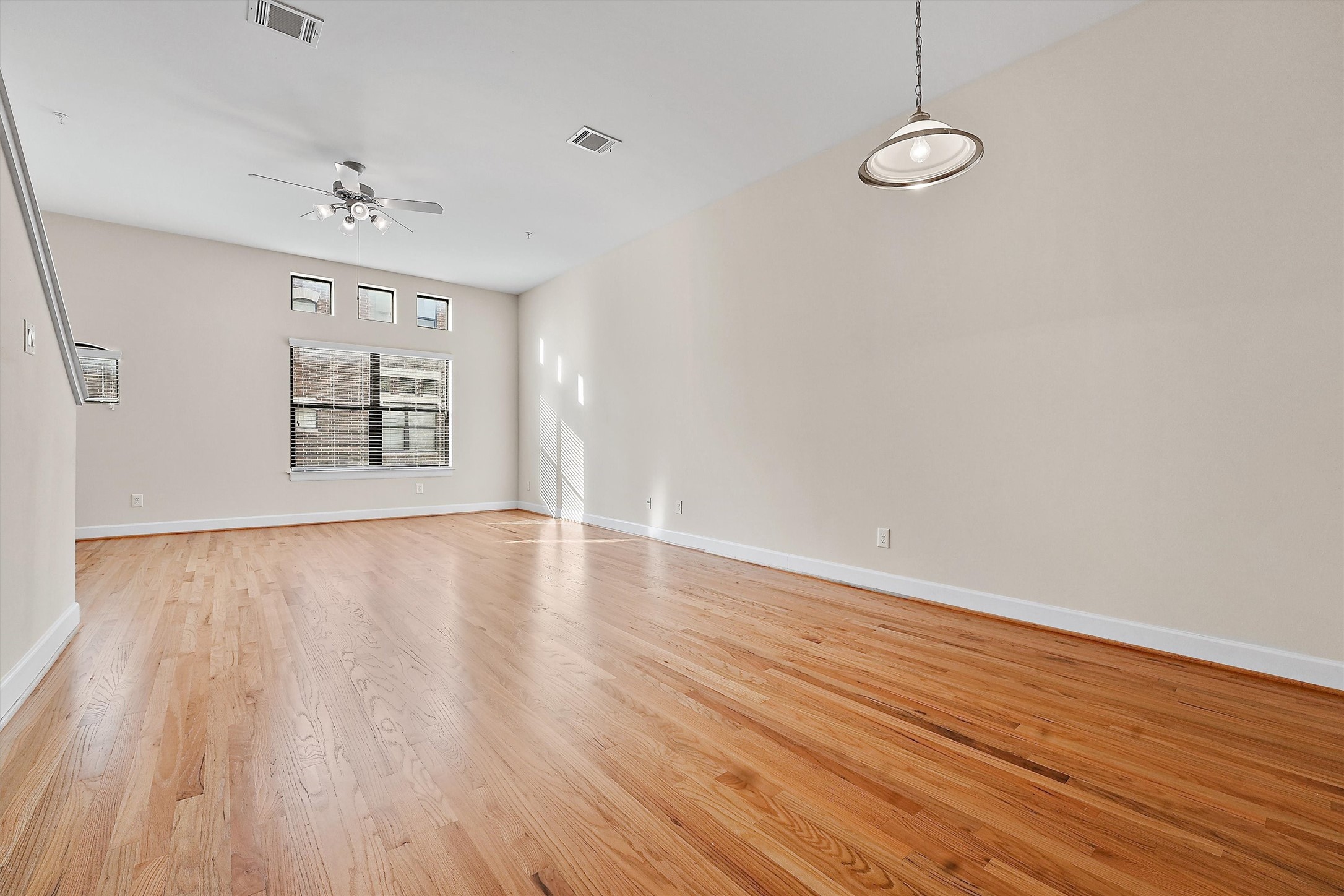 2710 Hullsmith Drive, Unit 903 Houston, TX 77063 - Photo 4 of 26 wooden floor in an empty room with a window