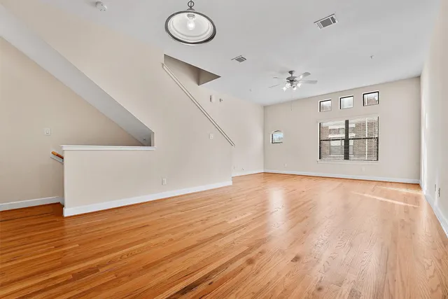 a view of a kitchen with wooden floor and a sink