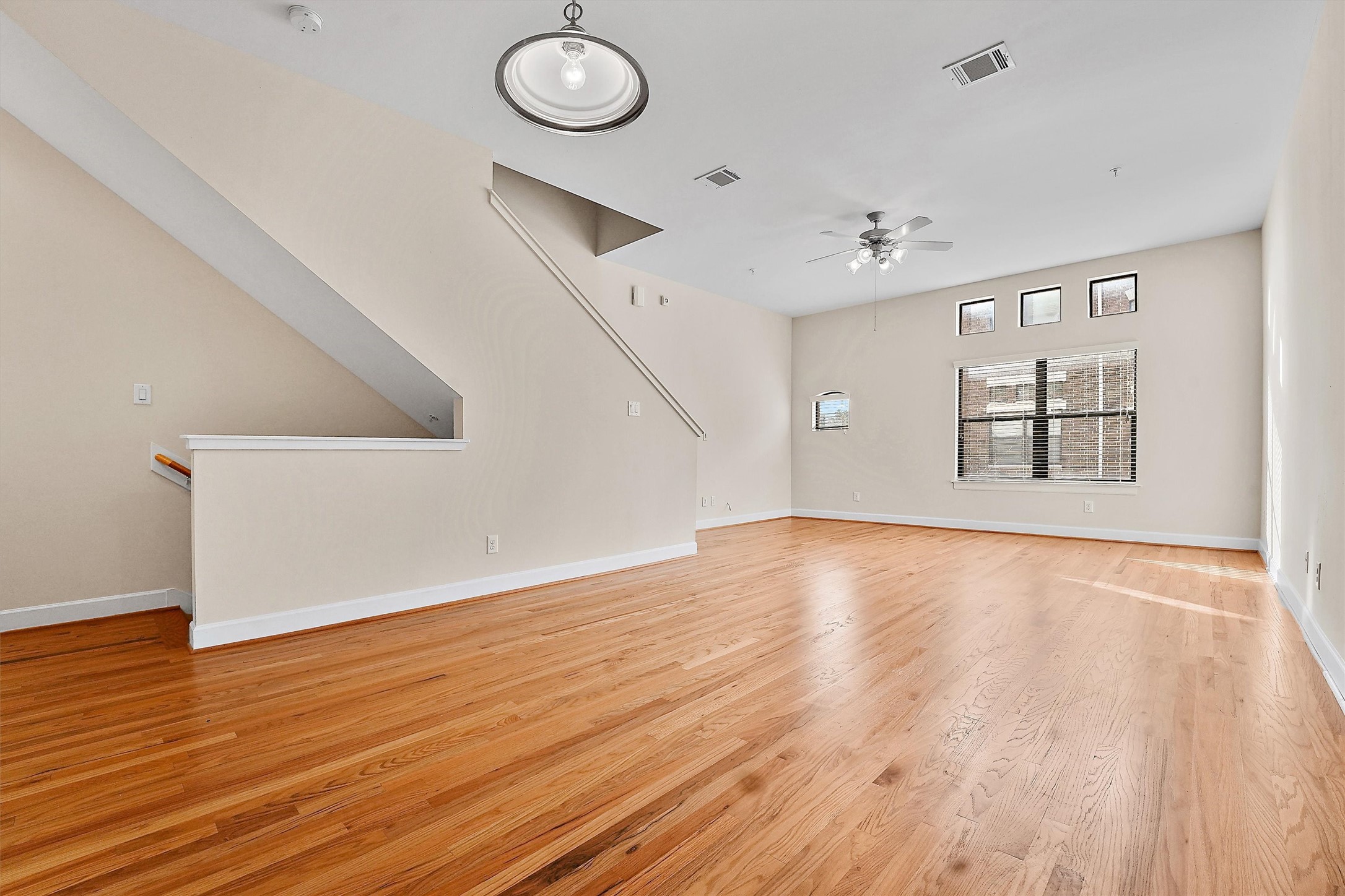 2710 Hullsmith Drive, Unit 903 Houston, TX 77063 - Photo 5 of 26 an empty room with wooden floor and windows