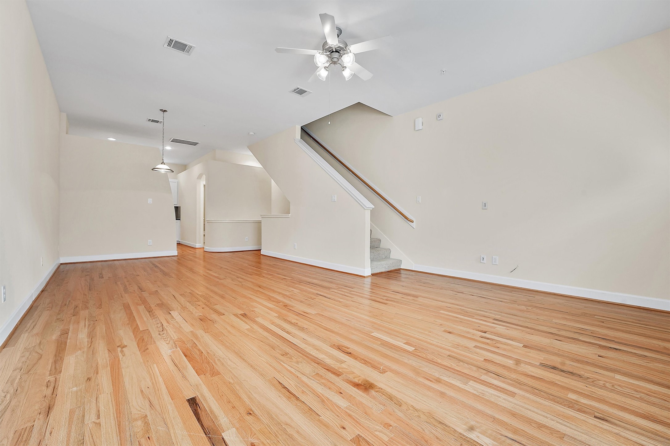 2710 Hullsmith Drive, Unit 903 Houston, TX 77063 - Photo 7 of 26 a view of an empty room with wooden floor and a ceiling fan