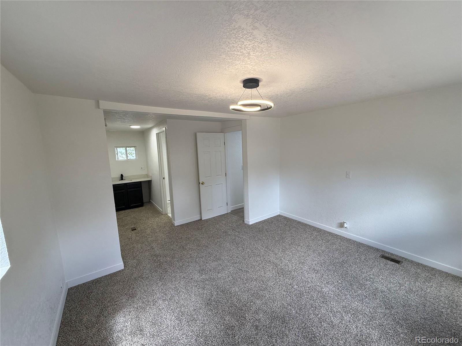 1045 Mac Davidson Circle Dacono, CO 80514 - Photo 12 of 32 an empty room with a bathroom