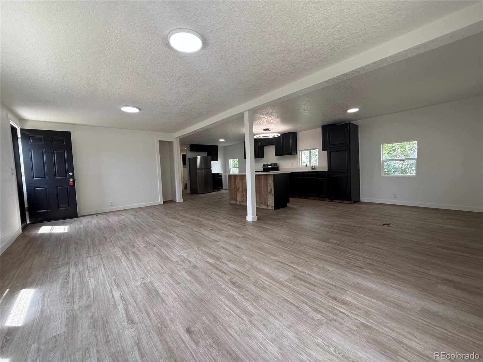 1045 Mac Davidson Circle Dacono, CO 80514 - Photo 15 of 32 a view of a room with kitchen and natural light