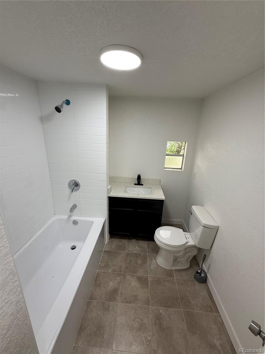 1045 Mac Davidson Circle Dacono, CO 80514 - Photo 22 of 32 a bathroom with a sink toilet and bathtub