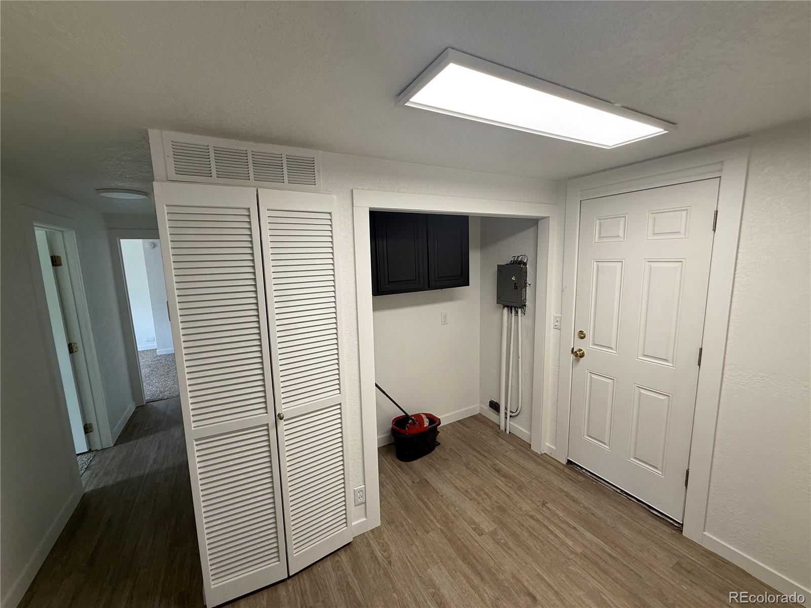 1045 Mac Davidson Circle Dacono, CO 80514 - Photo 23 of 32 a view of a livingroom with wooden floor and closet