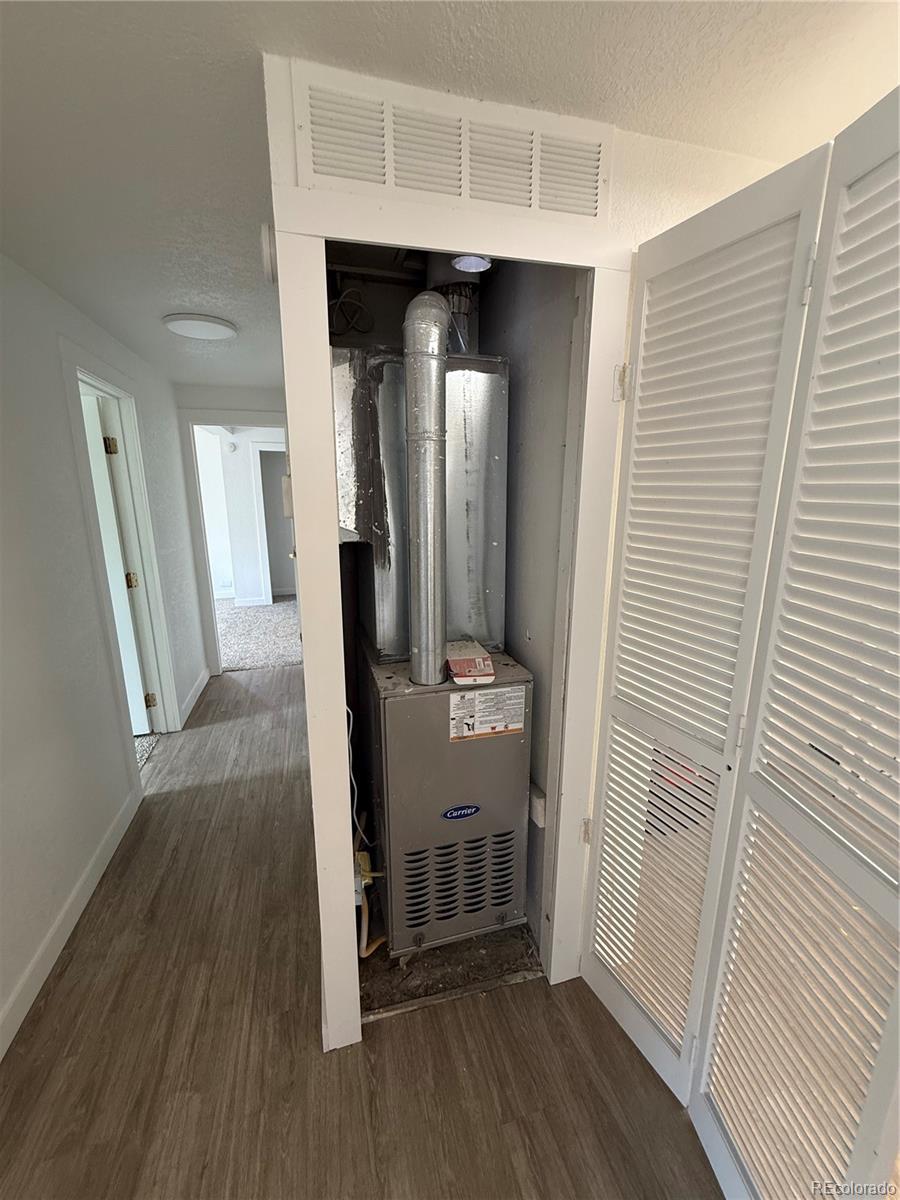 1045 Mac Davidson Circle Dacono, CO 80514 - Photo 24 of 32 a view of a hallway with wooden floor and staircase