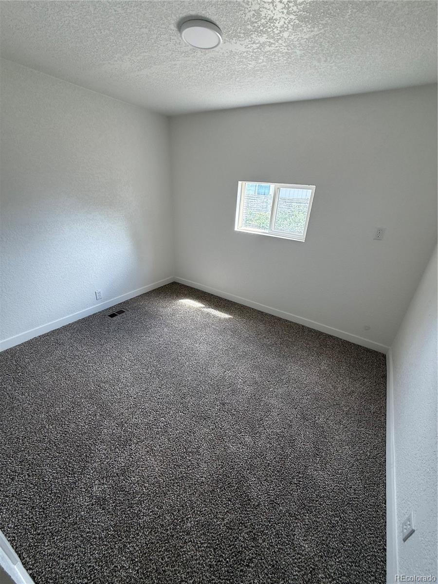 1045 Mac Davidson Circle Dacono, CO 80514 - Photo 26 of 32 an empty room with a workbench