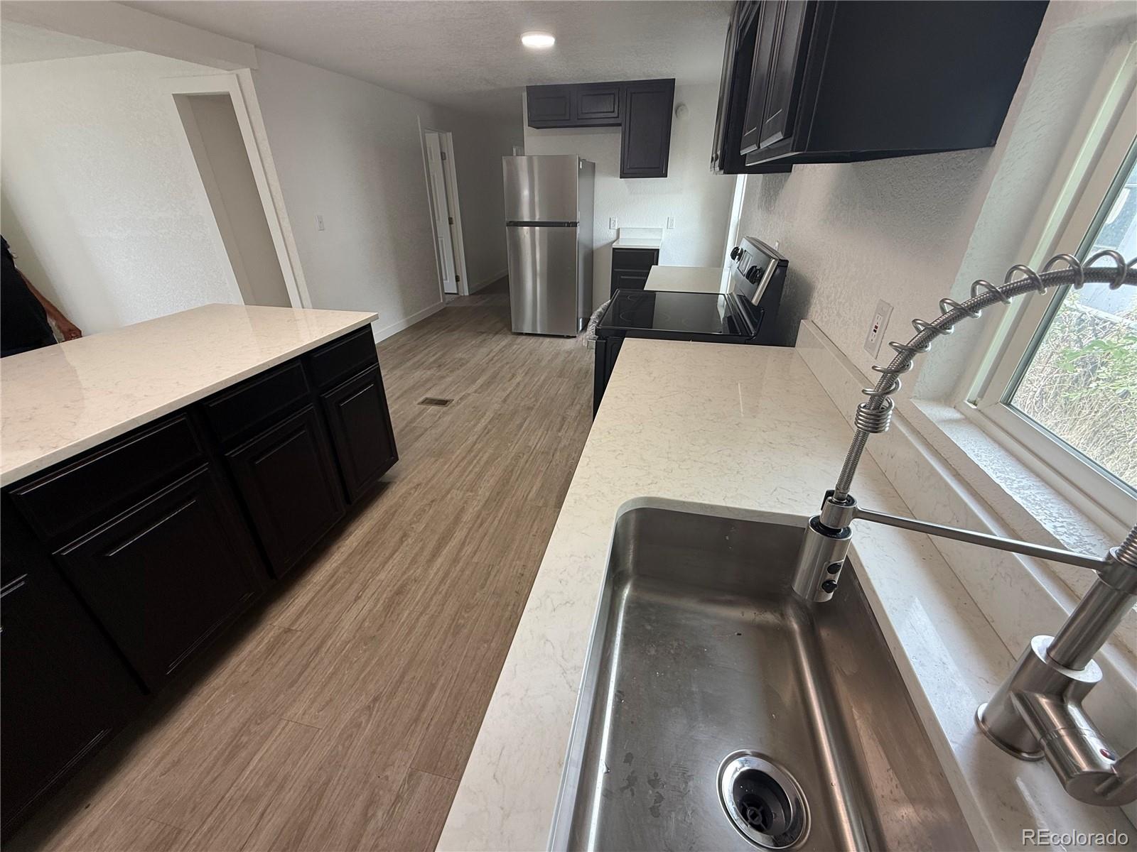 1045 Mac Davidson Circle Dacono, CO 80514 - Photo 29 of 32 a living room with a couch and a table