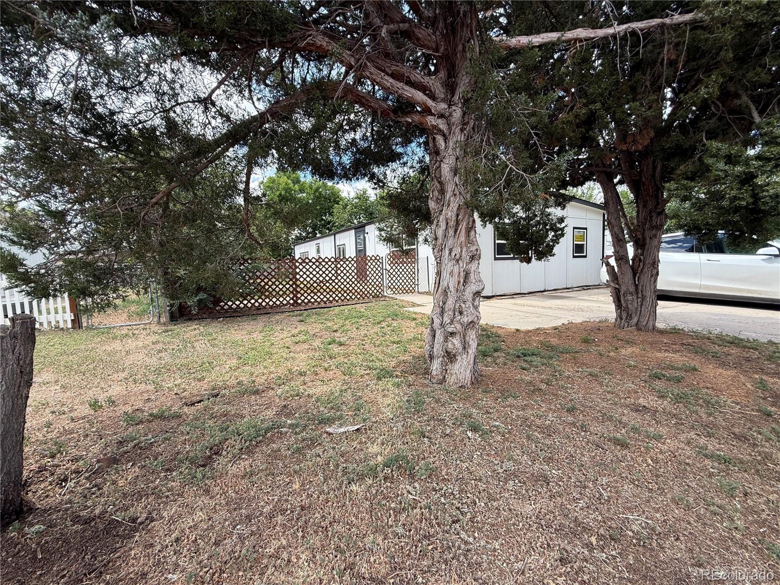 1045 Mac Davidson Circle Dacono, CO 80514 - Photo 32 of 32 a view of a yard with trees