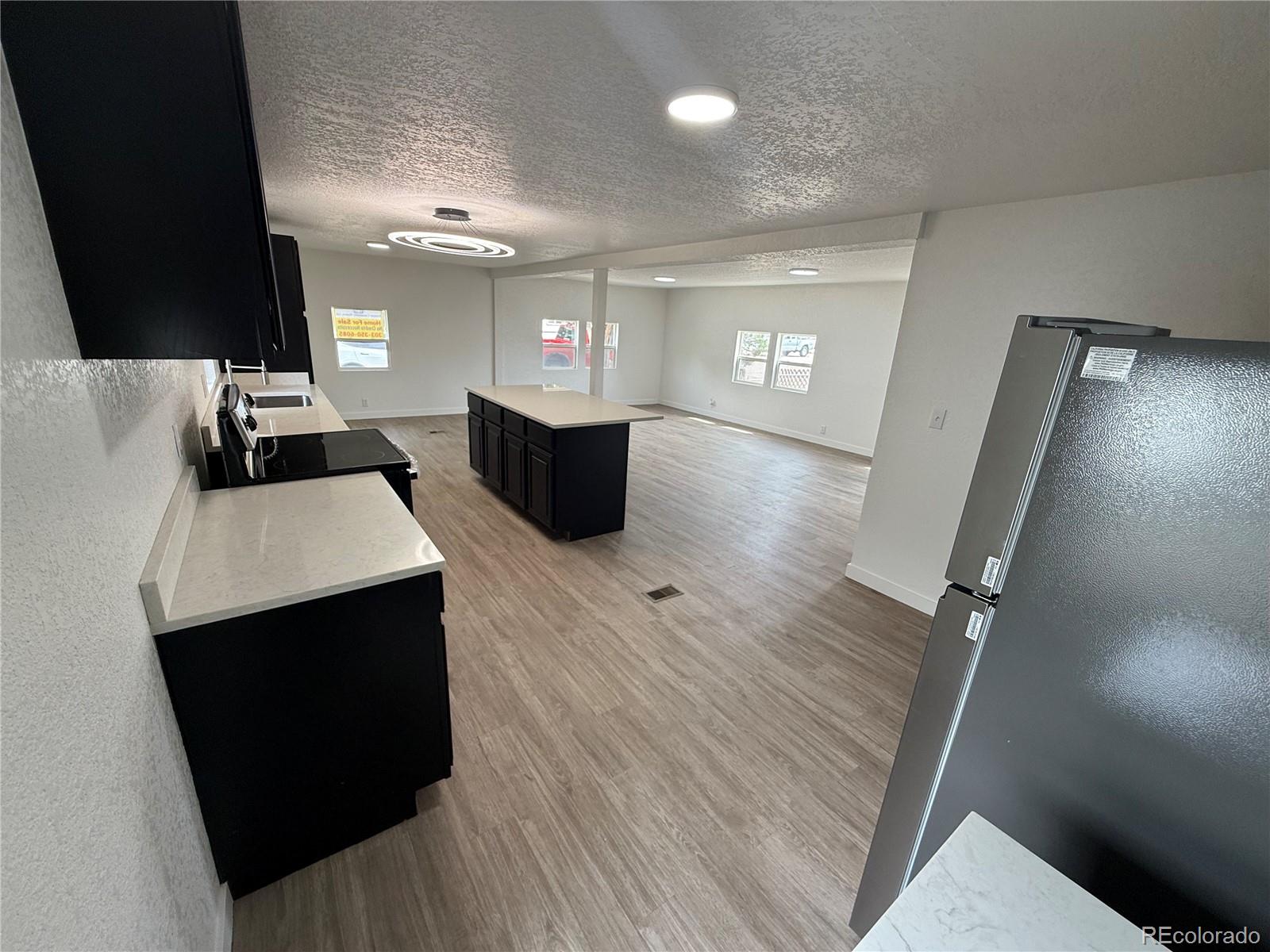 1045 Mac Davidson Circle Dacono, CO 80514 - Photo 9 of 32 a view of a living room washer and dryer