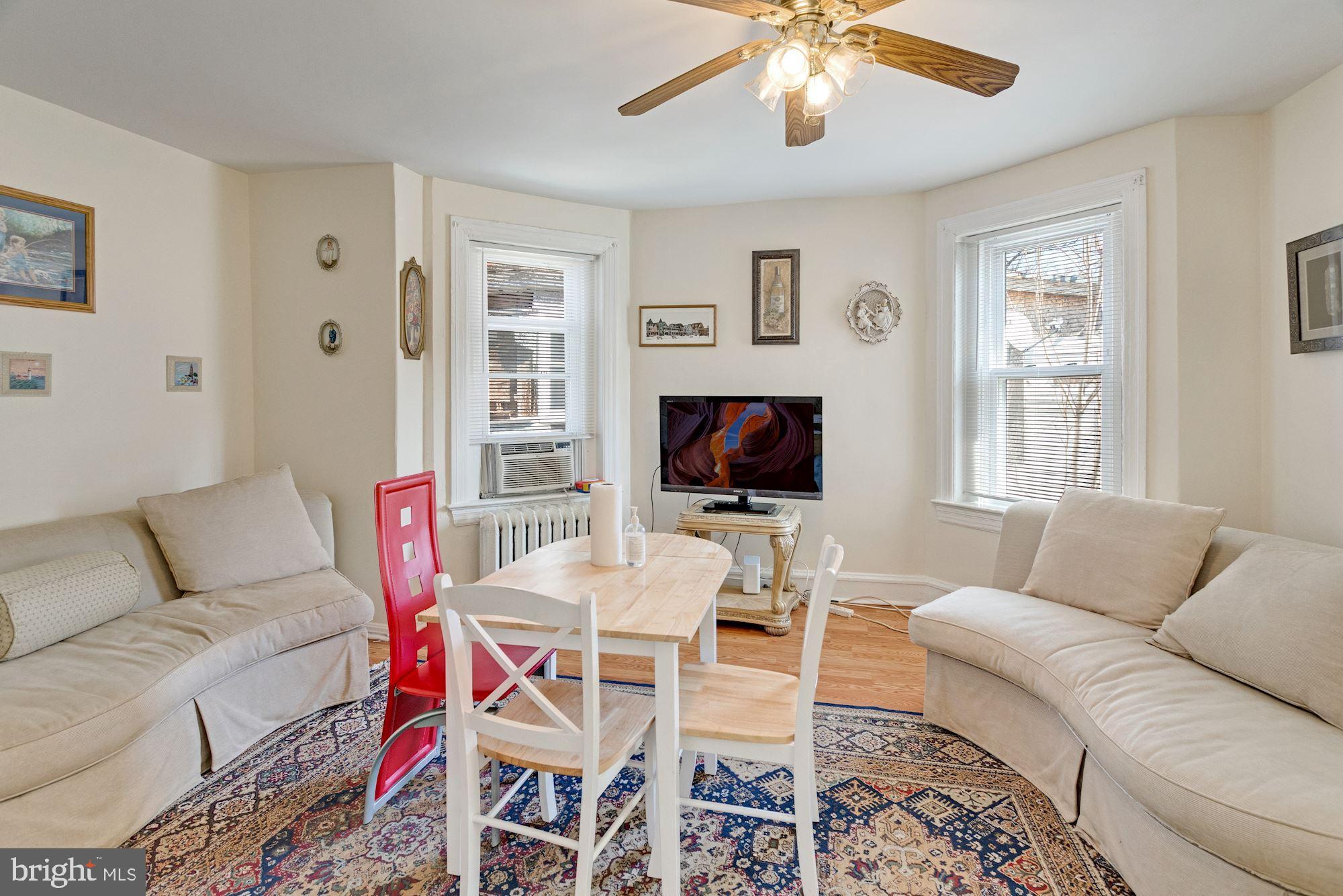 726 Rock Creek Church Road Northwest, Unit 2 Washington, DC 20010 - Photo 11 of 16 a living room with furniture a flat screen tv and a window