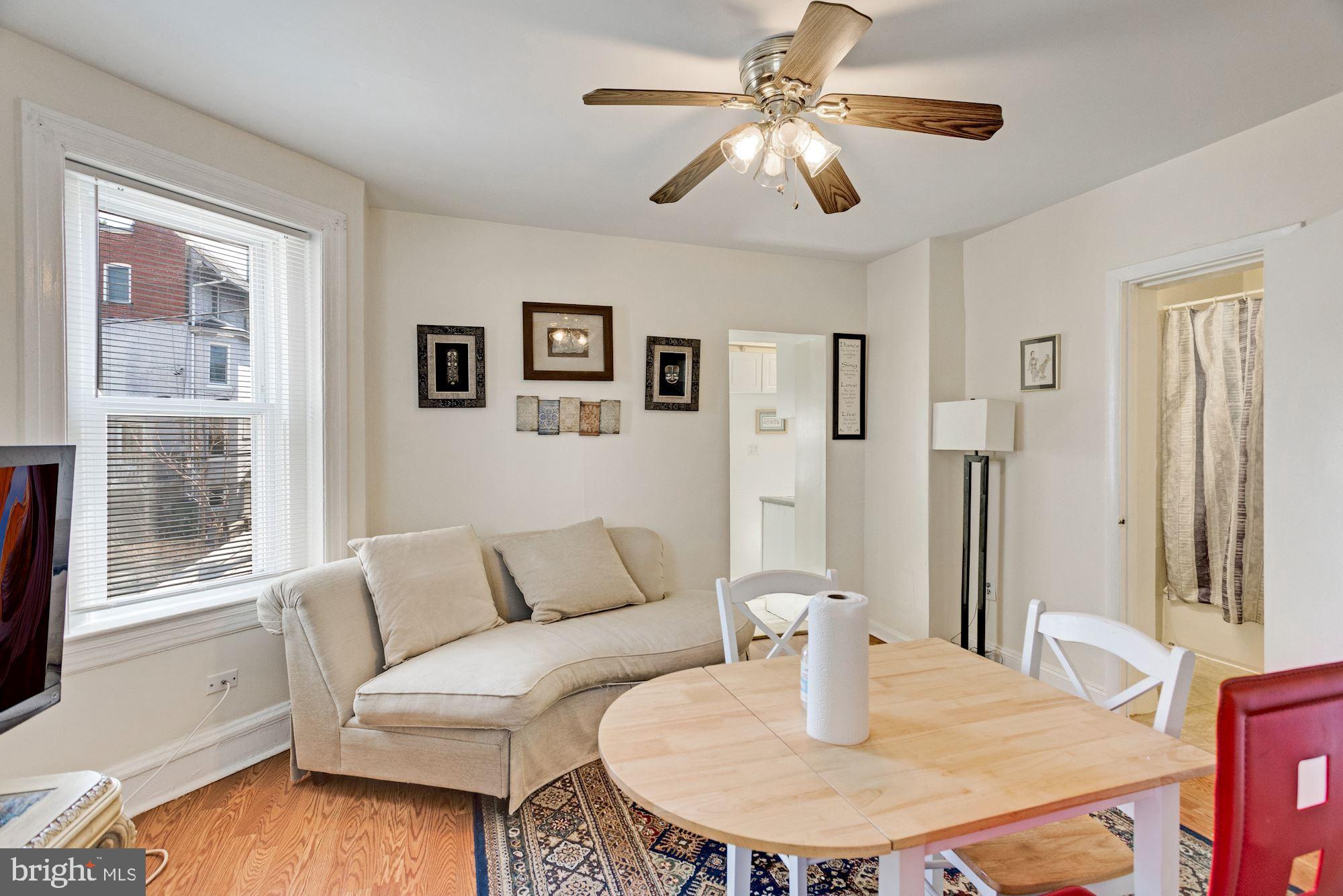 726 Rock Creek Church Road Northwest, Unit 2 Washington, DC 20010 - Photo 13 of 16 a living room with furniture and a large window
