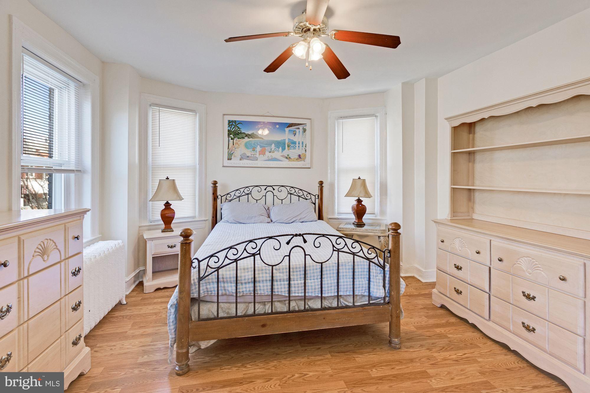 726 Rock Creek Church Road Northwest, Unit 2 Washington, DC 20010 - Photo 2 of 16 a bedroom with a bed and a window