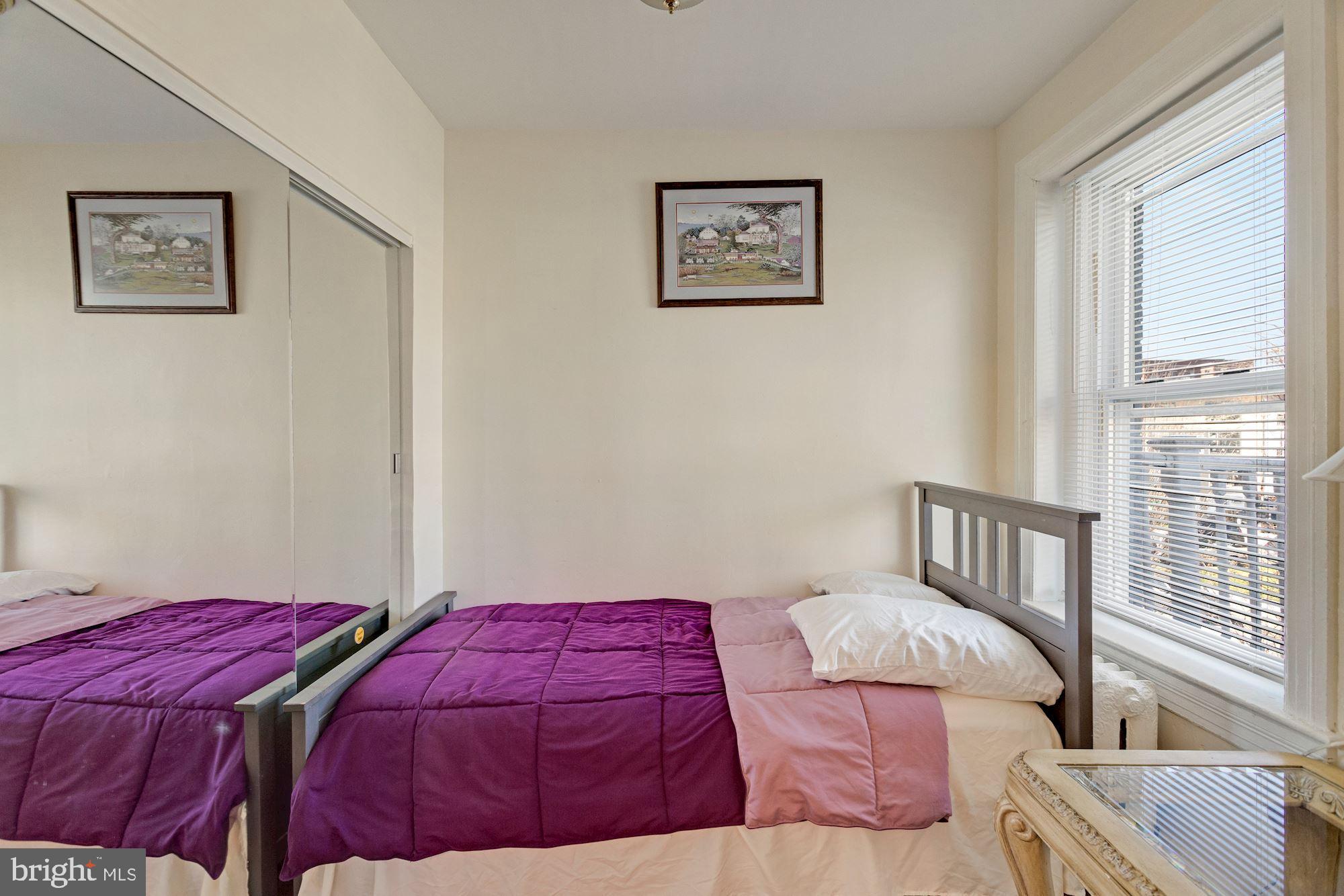 726 Rock Creek Church Road Northwest, Unit 2 Washington, DC 20010 - Photo 3 of 16 a bedroom with a bed and a painting on the wall