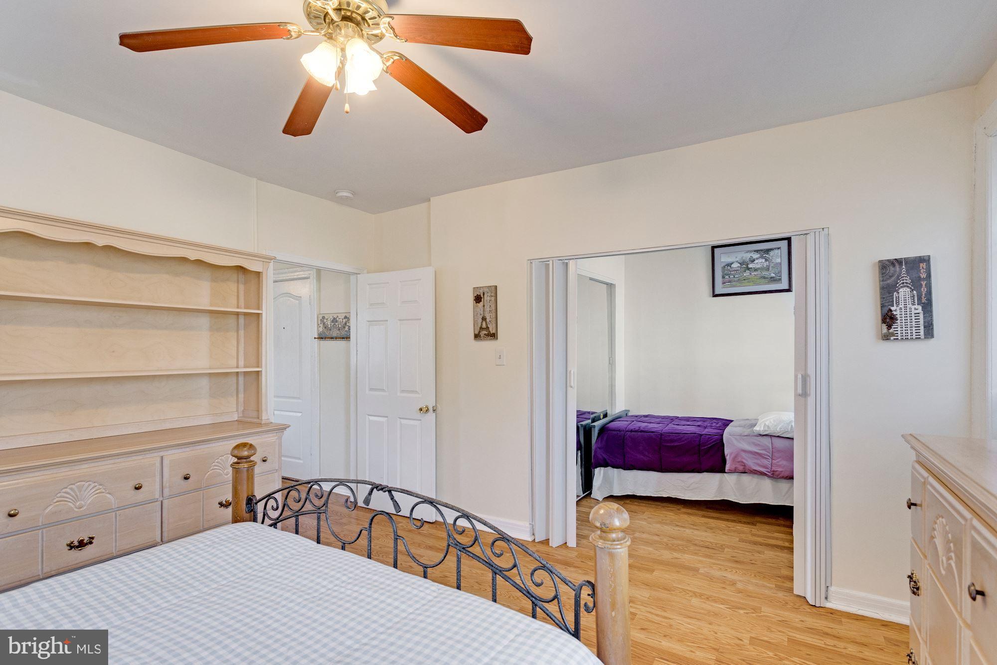 726 Rock Creek Church Road Northwest, Unit 2 Washington, DC 20010 - Photo 4 of 16 a bedroom with a bed and a chandelier