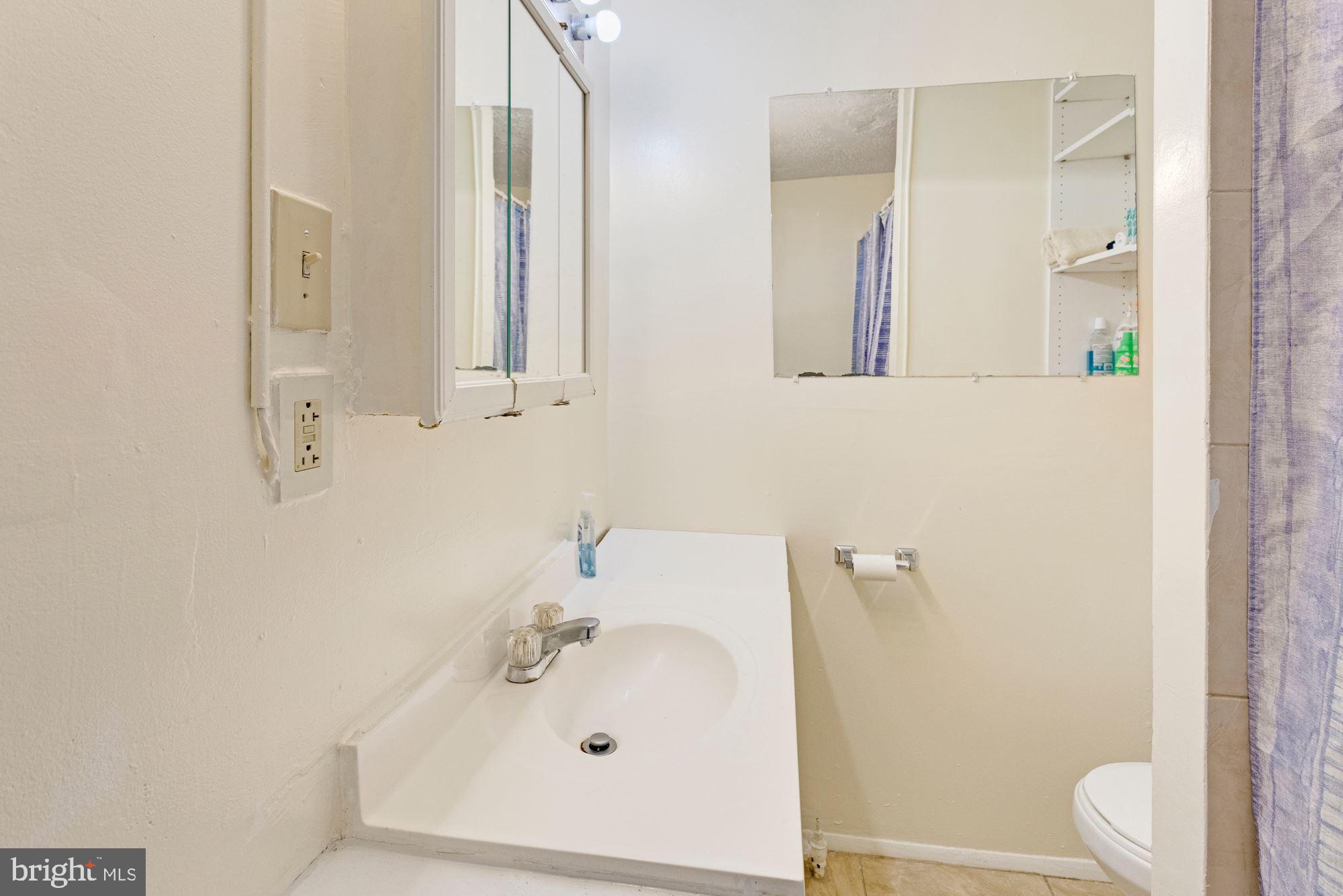 726 Rock Creek Church Road Northwest, Unit 2 Washington, DC 20010 - Photo 6 of 16 a bathroom with a sink and a mirror