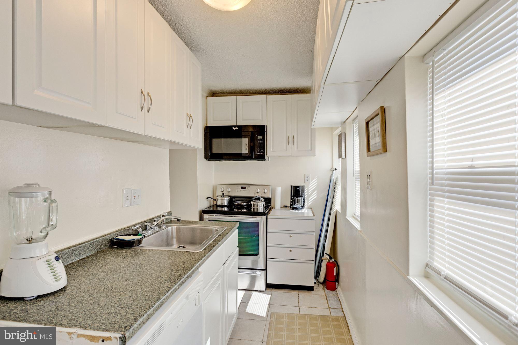 726 Rock Creek Church Road Northwest, Unit 2 Washington, DC 20010 - Photo 7 of 16 a kitchen with stainless steel appliances granite countertop a sink stove and refrigerator