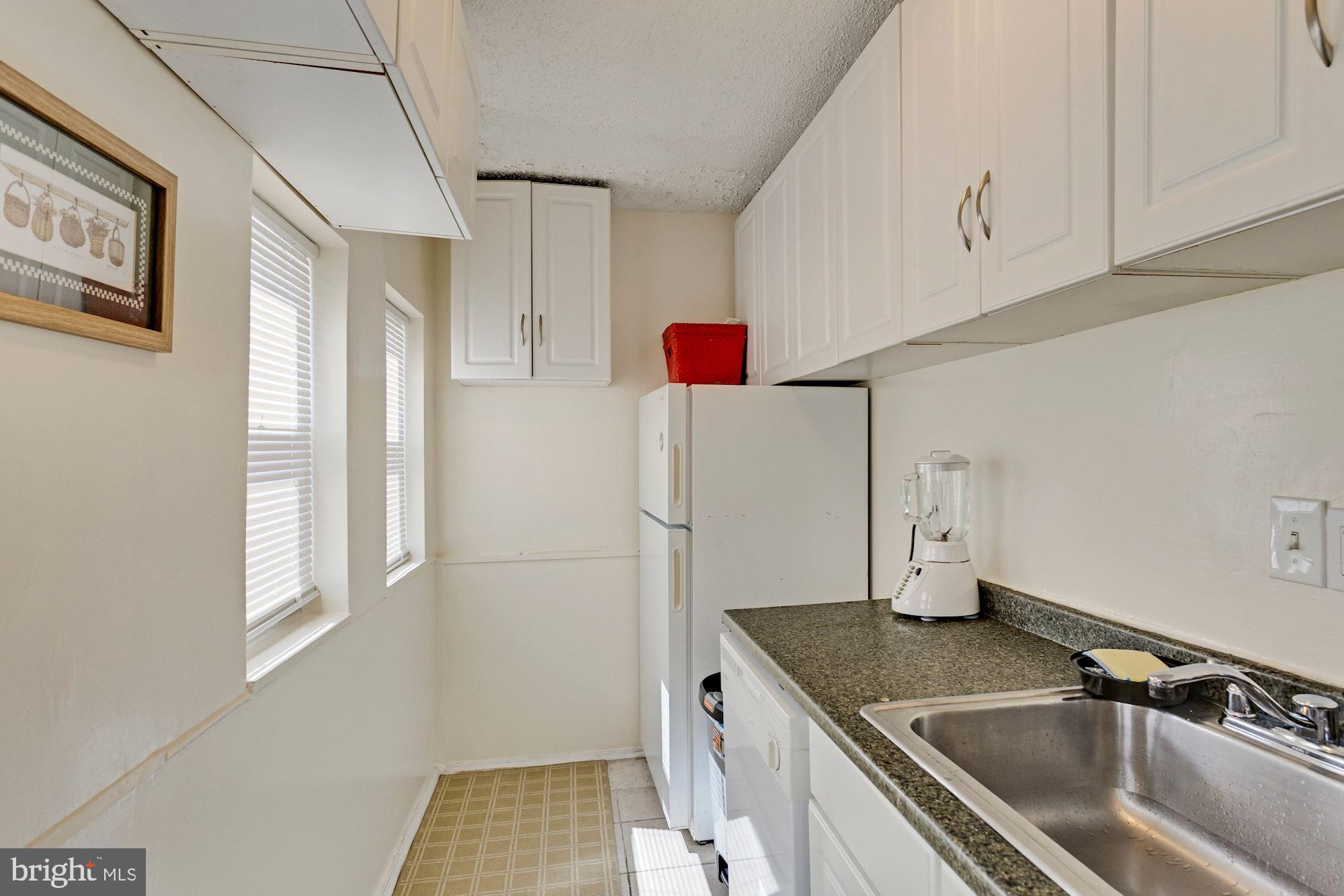 726 Rock Creek Church Road Northwest, Unit 2 Washington, DC 20010 - Photo 8 of 16 a kitchen with a sink stove and refrigerator