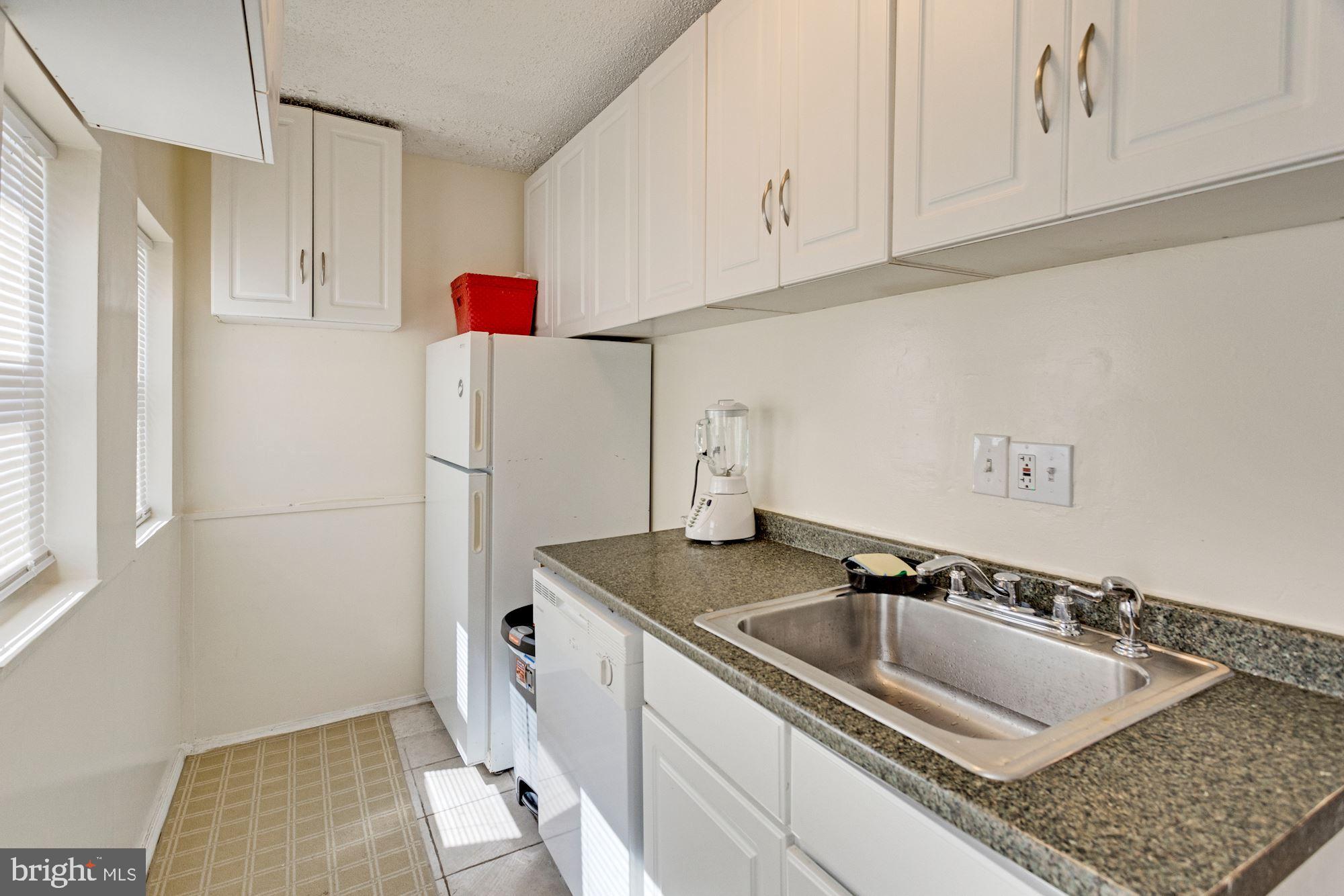 726 Rock Creek Church Road Northwest, Unit 2 Washington, DC 20010 - Photo 9 of 16 a kitchen with a sink and refrigerator