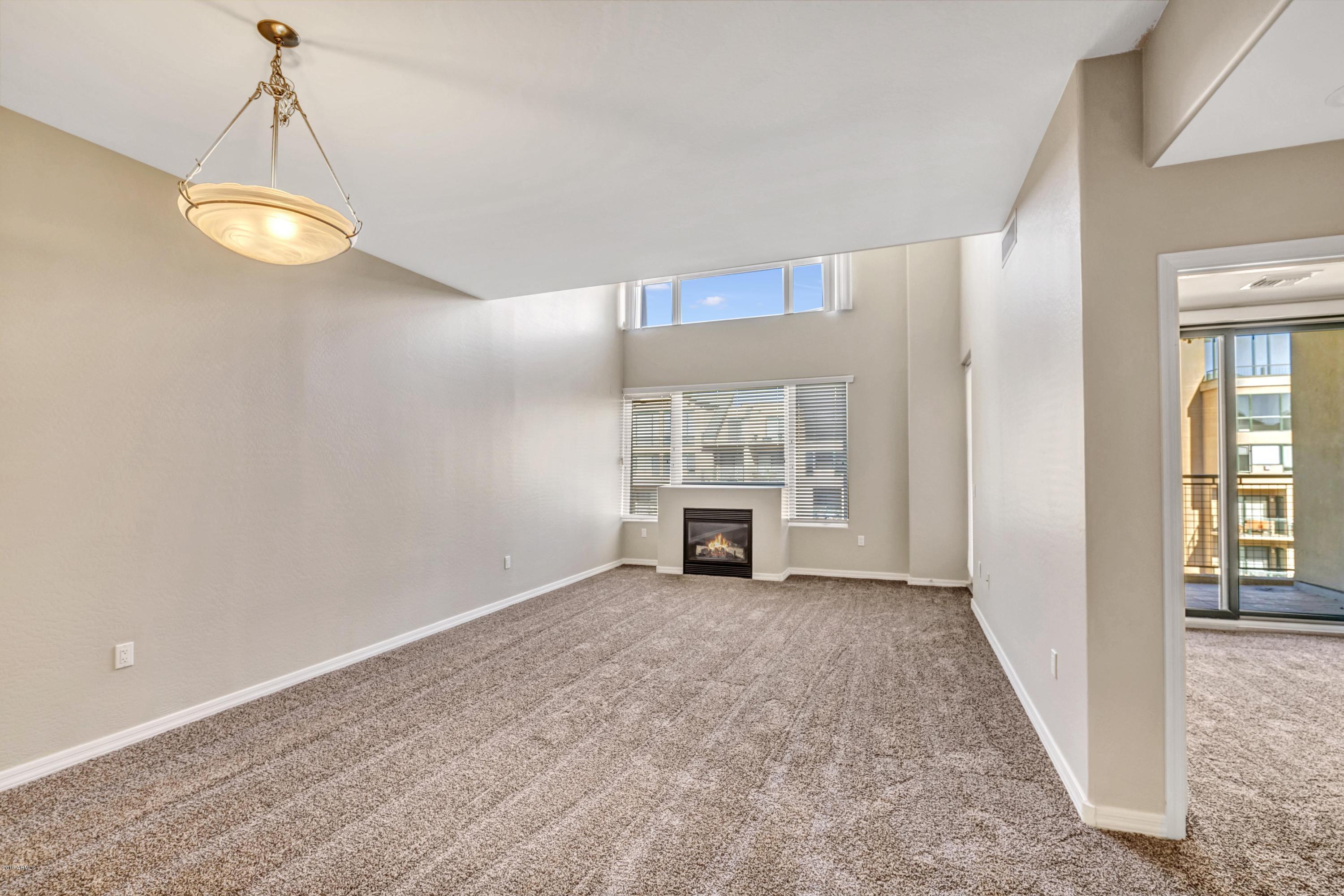 16 West Encanto Boulevard, Unit 615 Phoenix, AZ 85003 - Photo 1 of 33 an empty room with windows and fireplace