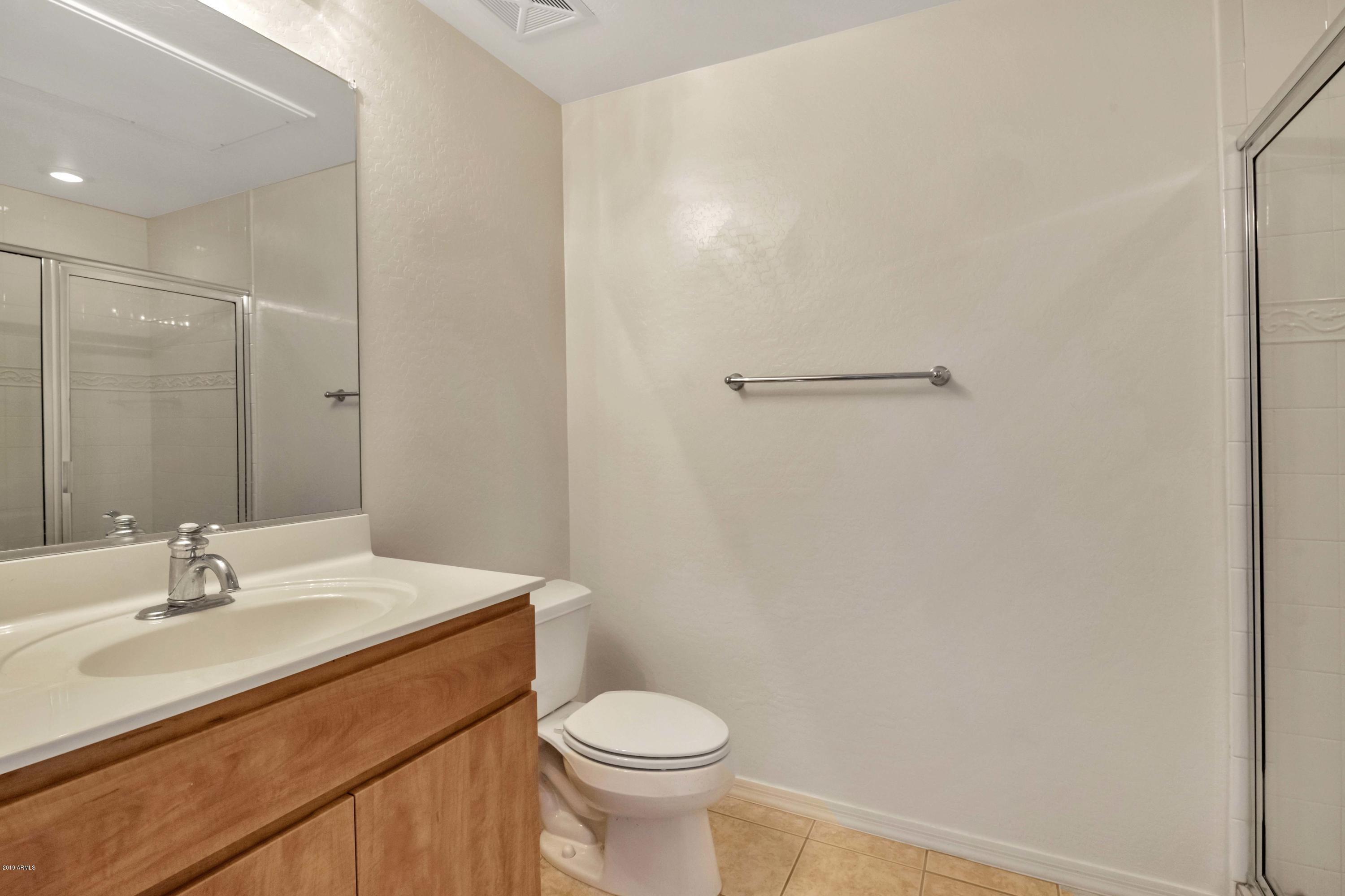 16 West Encanto Boulevard, Unit 615 Phoenix, AZ 85003 - Photo 11 of 33 a bathroom with a sink a toilet and shower