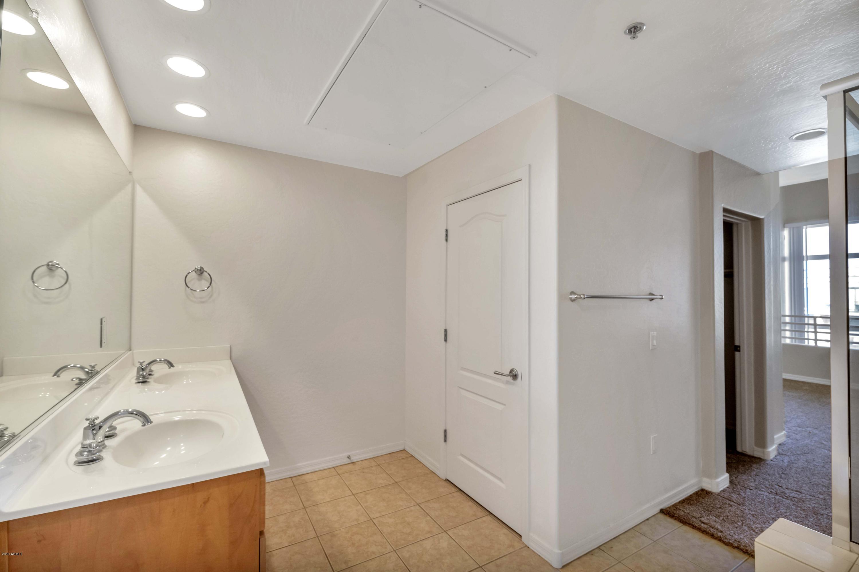 16 West Encanto Boulevard, Unit 615 Phoenix, AZ 85003 - Photo 20 of 33 a bathroom with a sink and a mirror