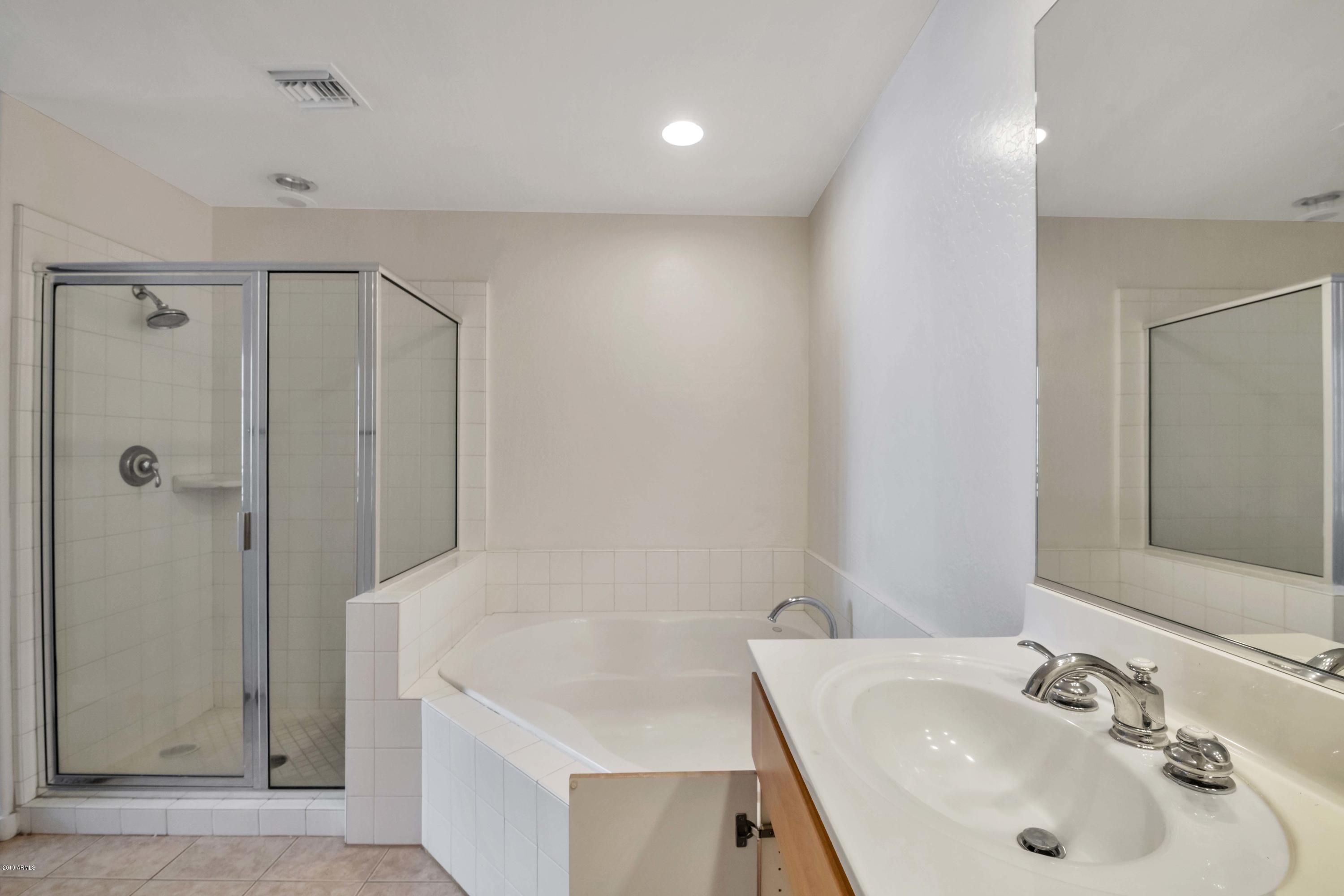 16 West Encanto Boulevard, Unit 615 Phoenix, AZ 85003 - Photo 21 of 33 a bathroom with a sink a shower and a mirror