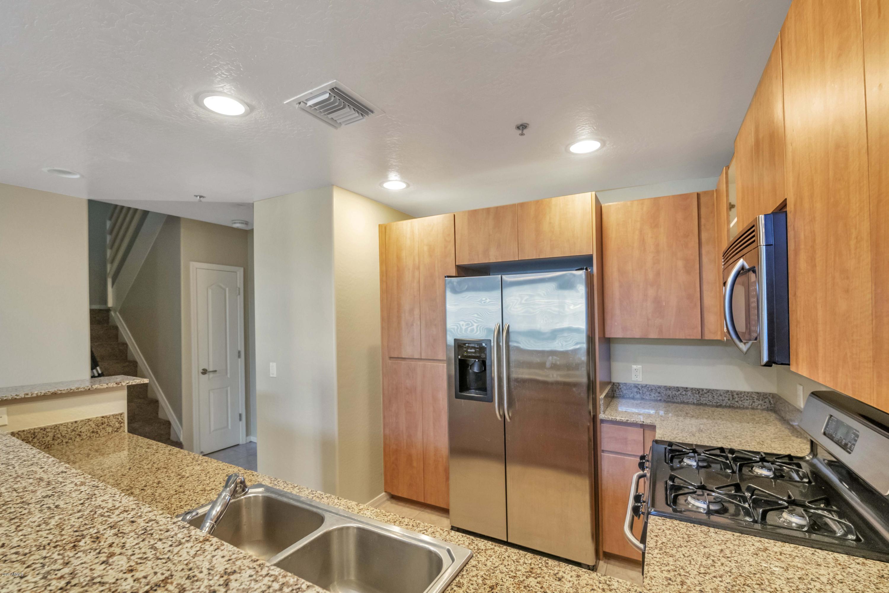 16 West Encanto Boulevard, Unit 615 Phoenix, AZ 85003 - Photo 4 of 33 a kitchen with stainless steel appliances granite countertop a refrigerator and a sink