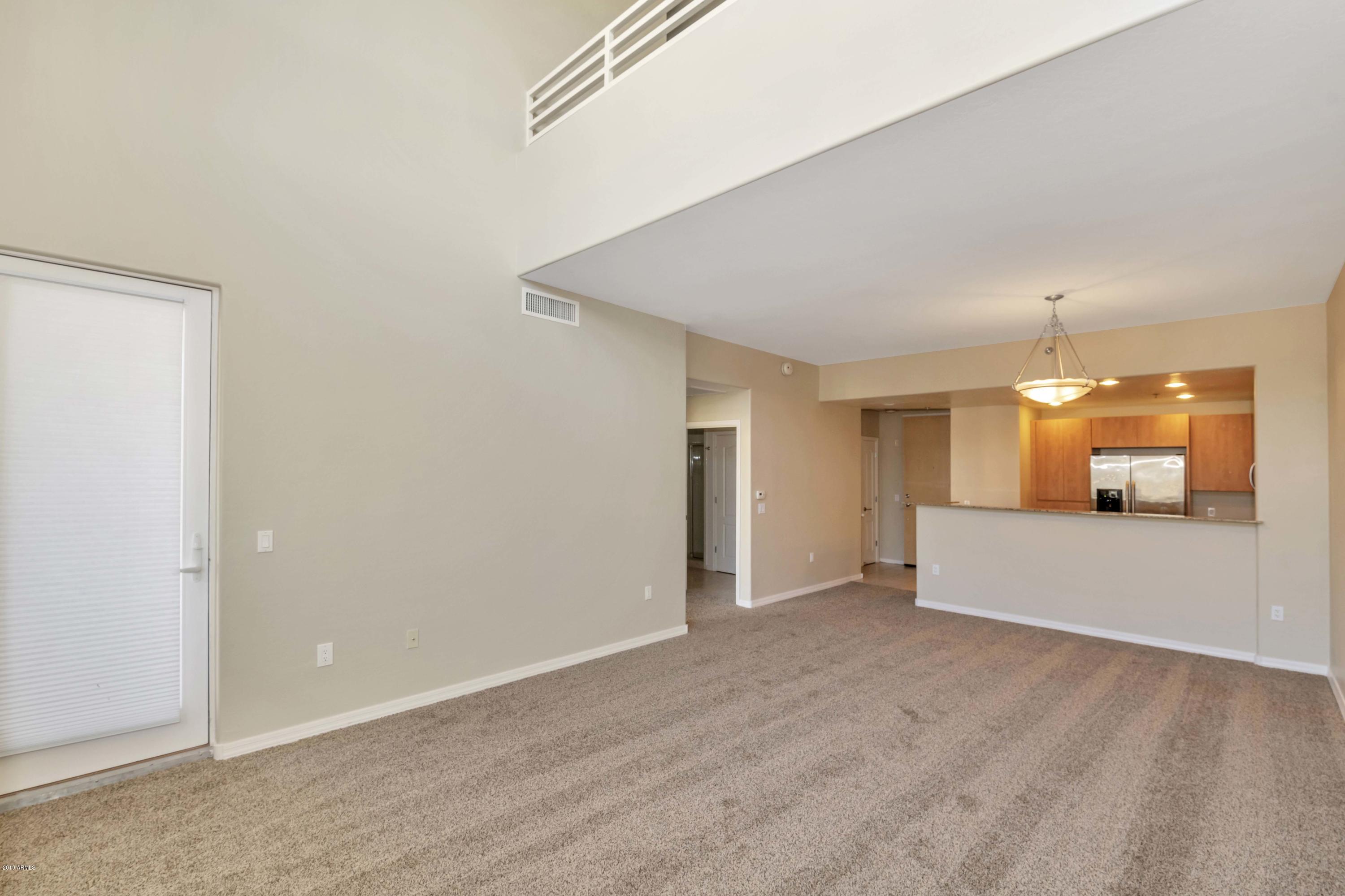 16 West Encanto Boulevard, Unit 615 Phoenix, AZ 85003 - Photo 7 of 33 an empty room with a fireplace and painted walls