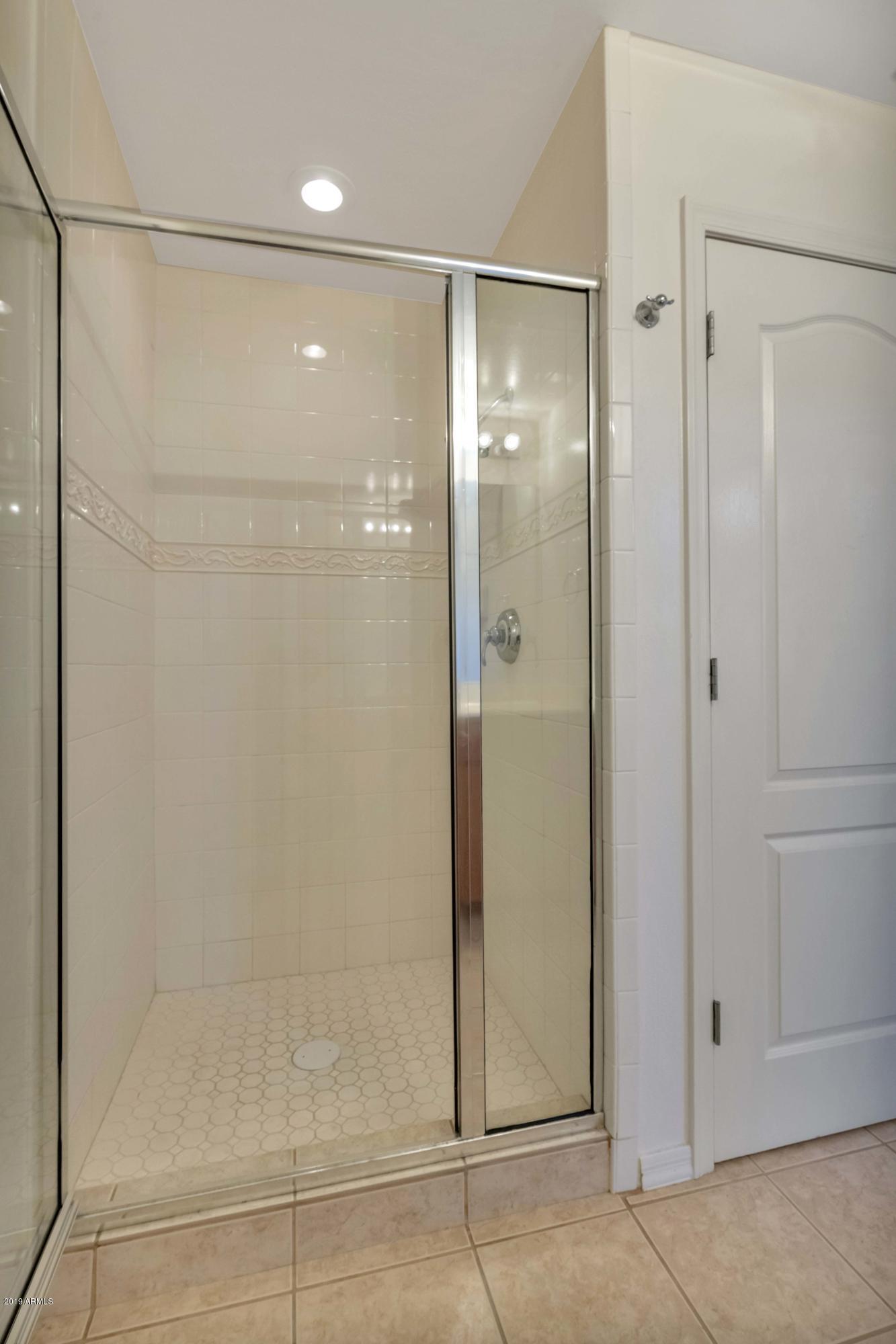 16 West Encanto Boulevard, Unit 615 Phoenix, AZ 85003 - Photo 10 of 33 a bathroom with a shower and a glass door