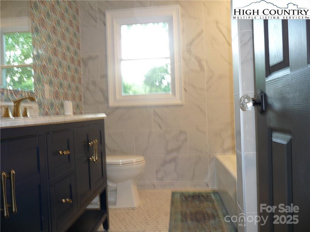 384 New River Heights Road, Unit 12 Boone, NC 28607 - Photo 15 of 30 a bathroom with a sink a toilet and shower