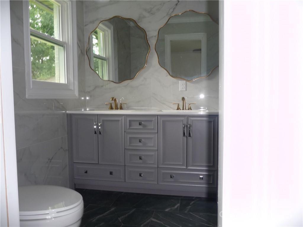 384 New River Heights Road, Unit 12 Boone, NC 28607 - Photo 19 of 30 a bathroom with a double vanity sink mirror and toilet