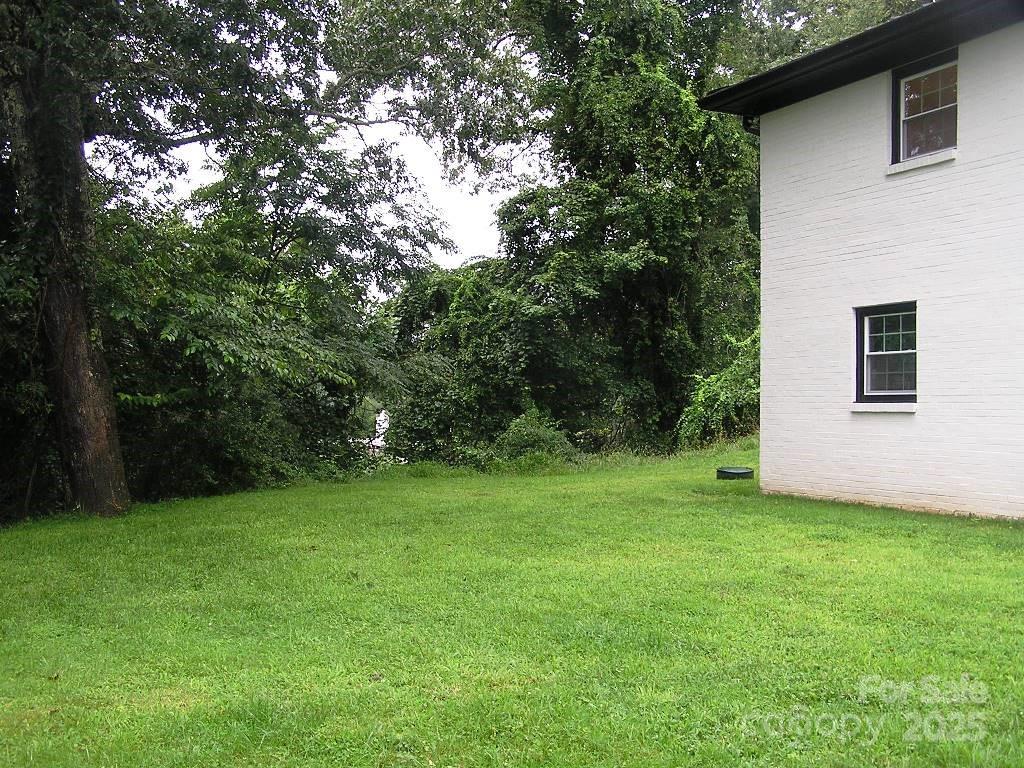 384 New River Heights Road, Unit 12 Boone, NC 28607 - Photo 26 of 30 a view of a backyard with potted plants and large trees