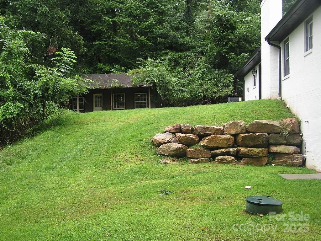 384 New River Heights Road, Unit 12 Boone, NC 28607 - Photo 27 of 30 a view of a house with backyard sitting area and garden