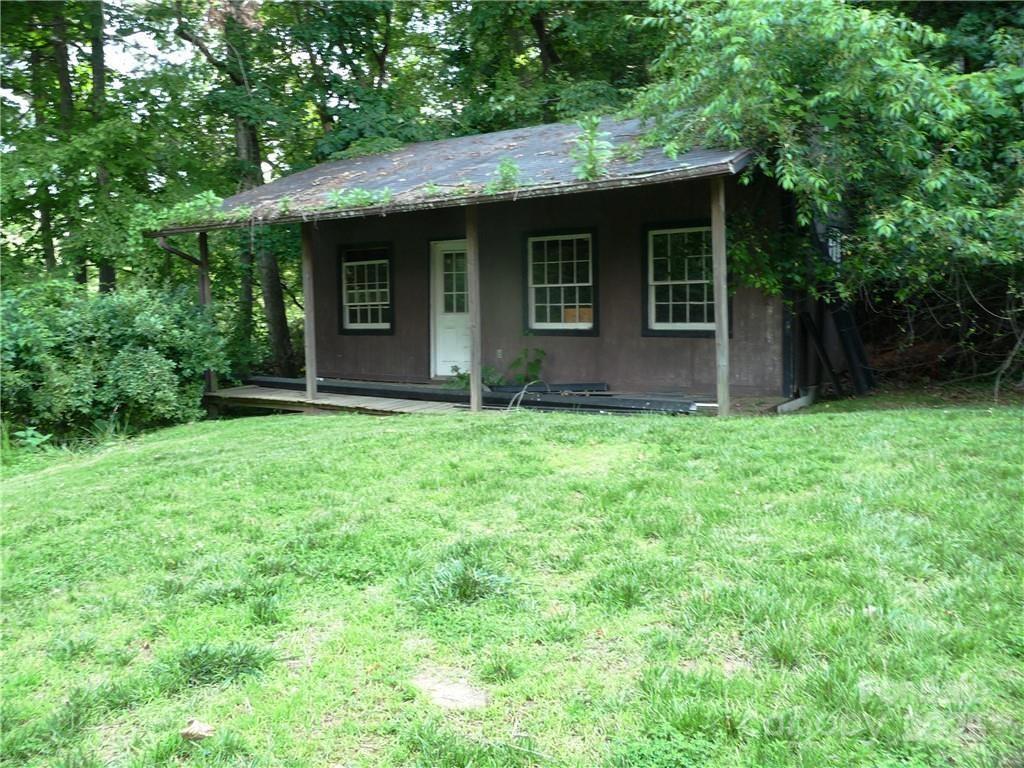 384 New River Heights Road, Unit 12 Boone, NC 28607 - Photo 28 of 30 a view of a brick house with a big yard large tree and a large window