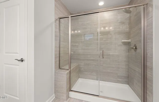 a bathroom with a glass shower door