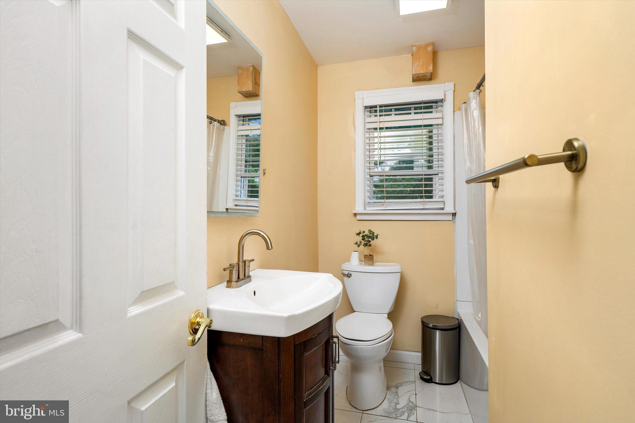 319 Station Road Roebling, NJ 08554 - Photo 9 of 15 a bathroom with a sink a toilet and mirror
