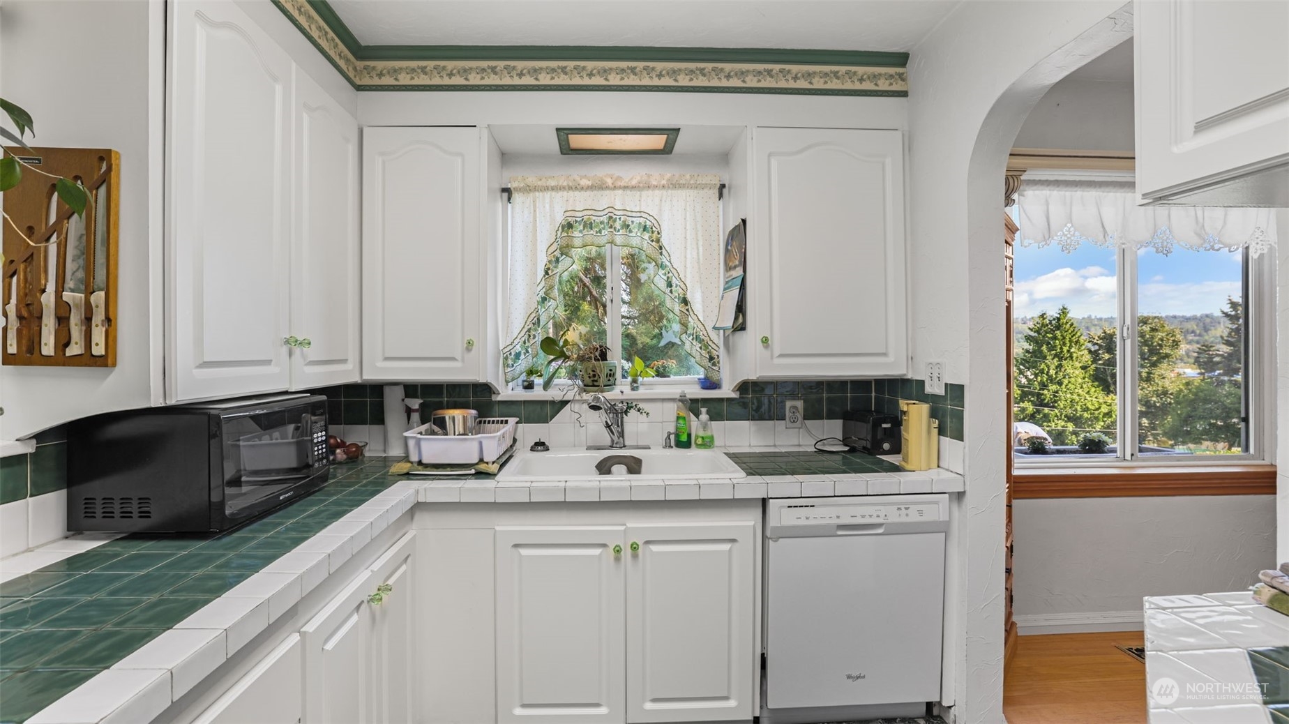 217 Hardie Avenue Southwest Renton, WA 98057 - Photo 11 of 29 a kitchen with white cabinets and window