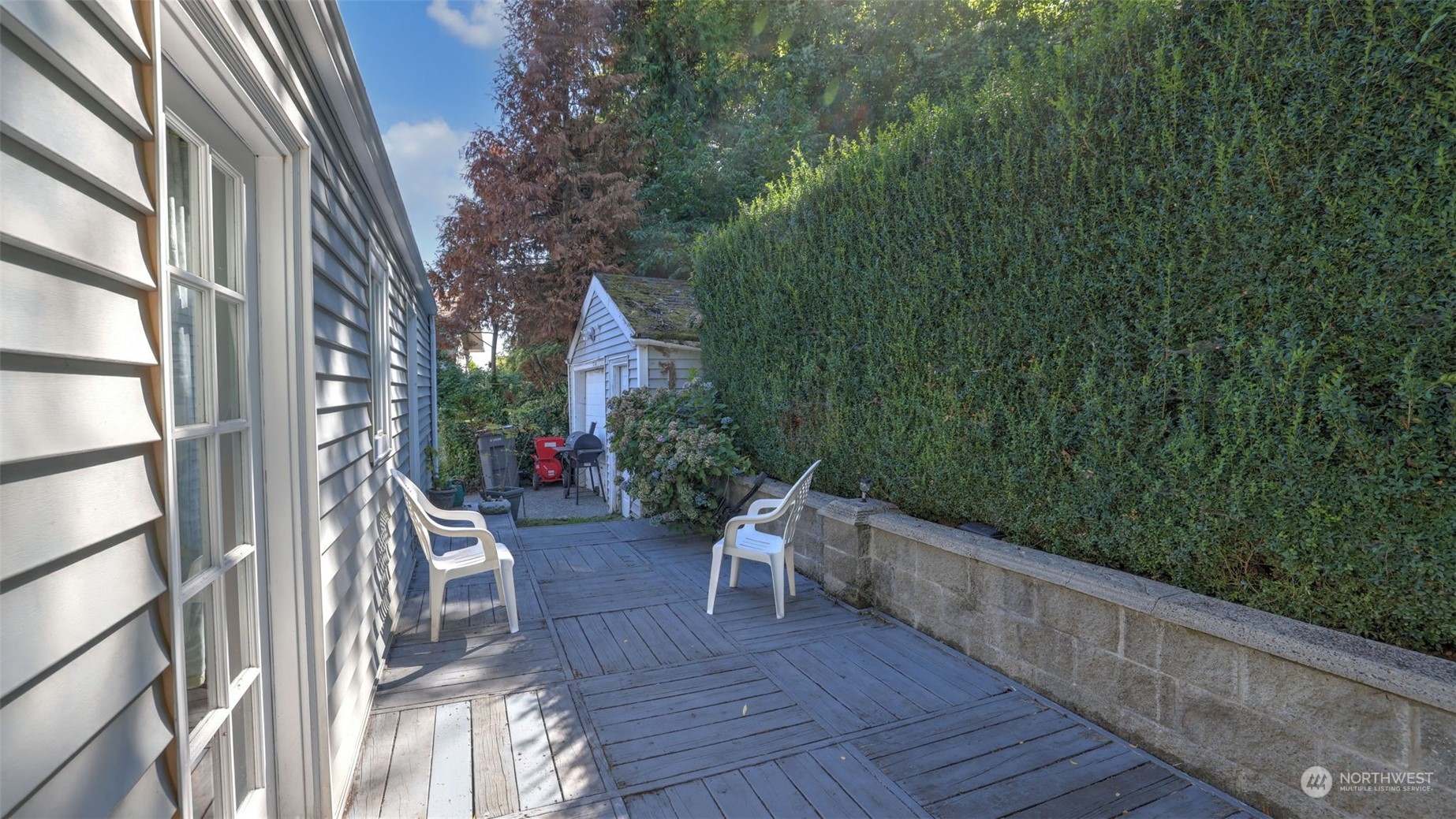 217 Hardie Avenue Southwest Renton, WA 98057 - Photo 18 of 29 a porch with a bench next to a yard