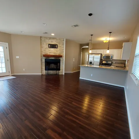a room with a fireplace and a wooden floor