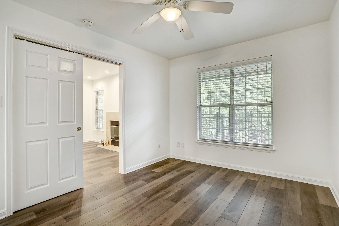 7685 Northcross Drive, Unit 426 Austin, TX 78757 - Photo 11 of 35 a view of an empty room with wooden floor and a window
