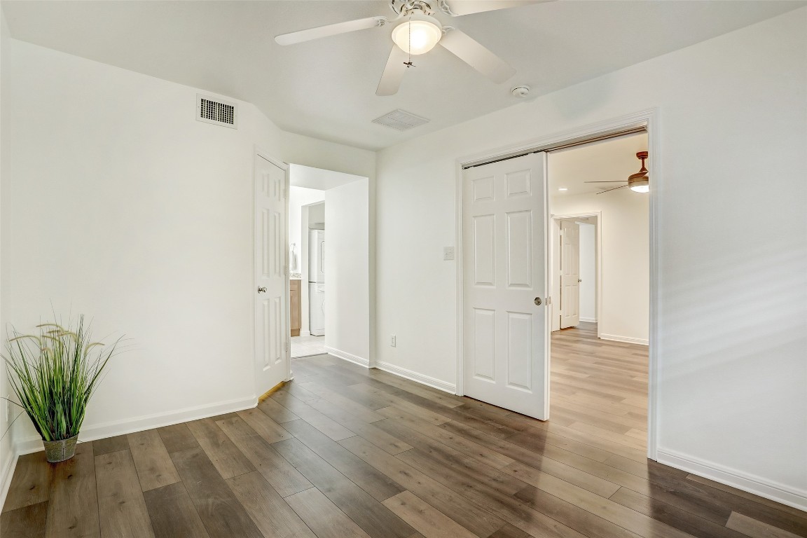 7685 Northcross Drive, Unit 426 Austin, TX 78757 - Photo 12 of 35 an empty room with wooden floor and mirror