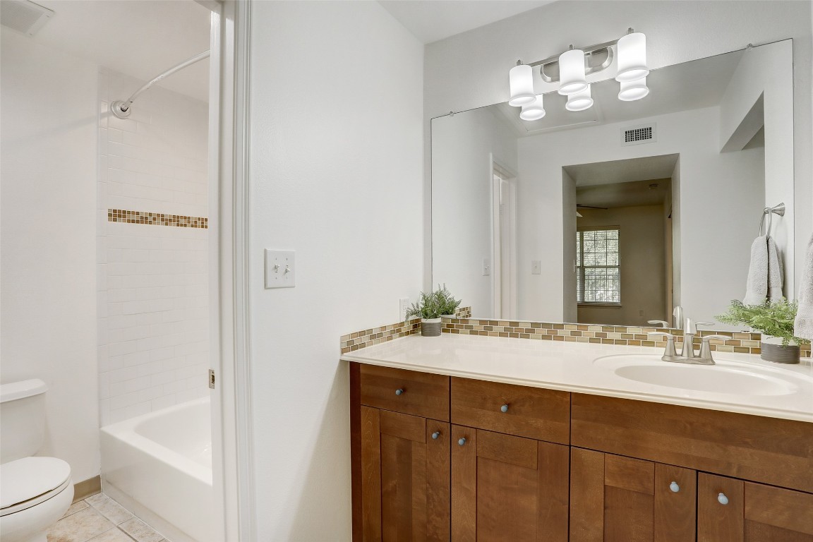 7685 Northcross Drive, Unit 426 Austin, TX 78757 - Photo 18 of 35 a bathroom with a sink a toilet and shower